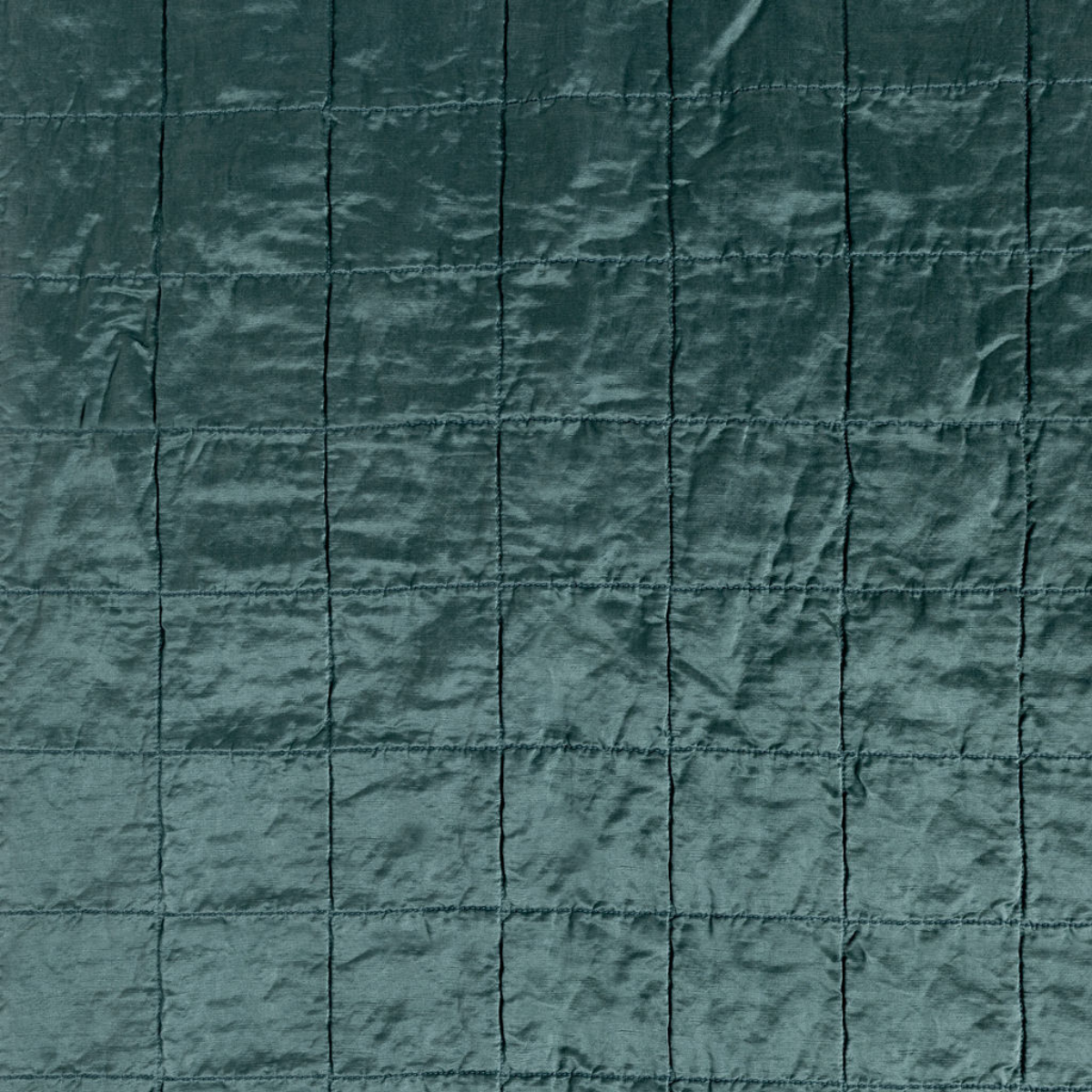 Cenote: a shot of square-quilted charmeuse in cenote, a vibrant ocean-inspired blue-green.