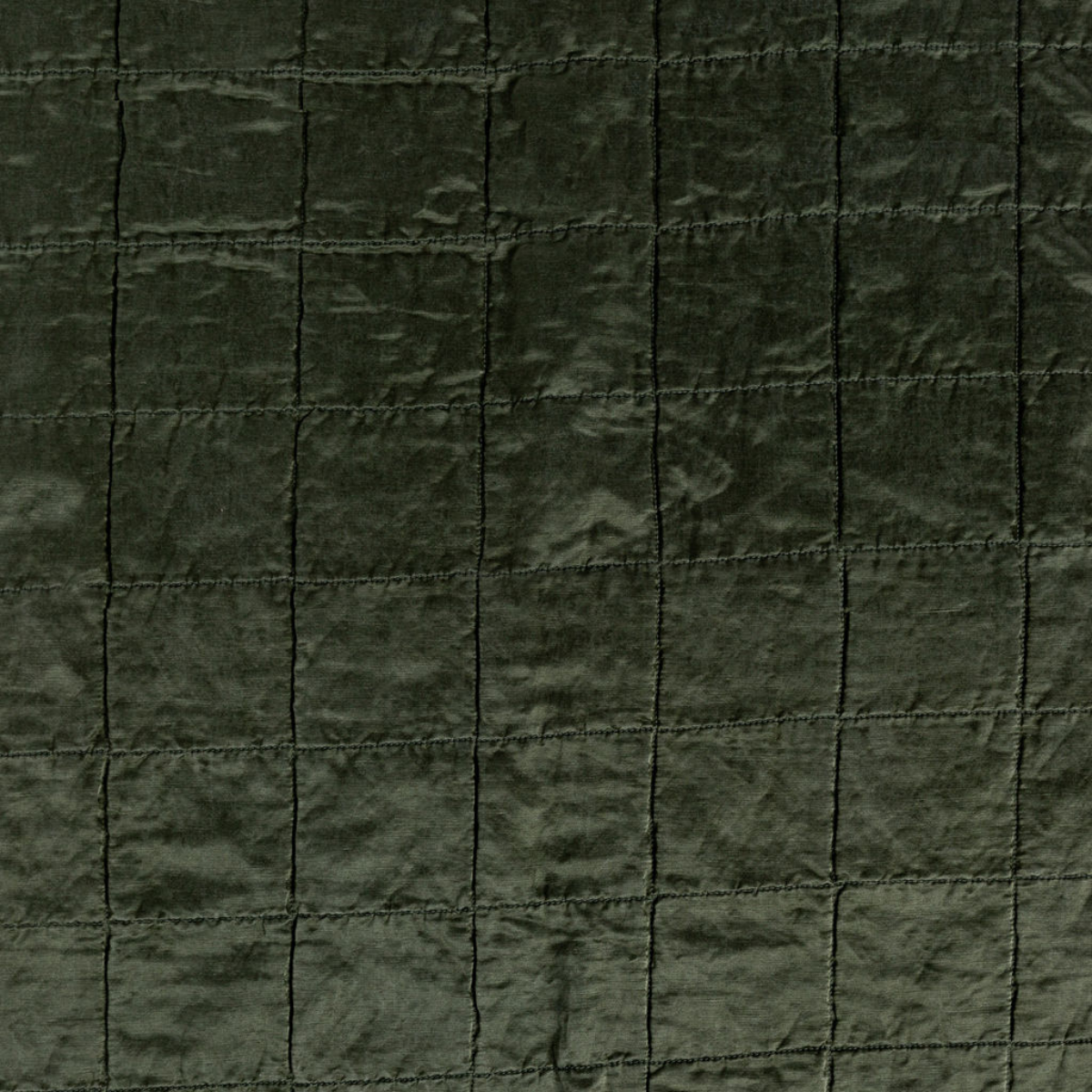 Juniper: a shot of square-quilted charmeuse in juniper, a deeply saturated dark green.
