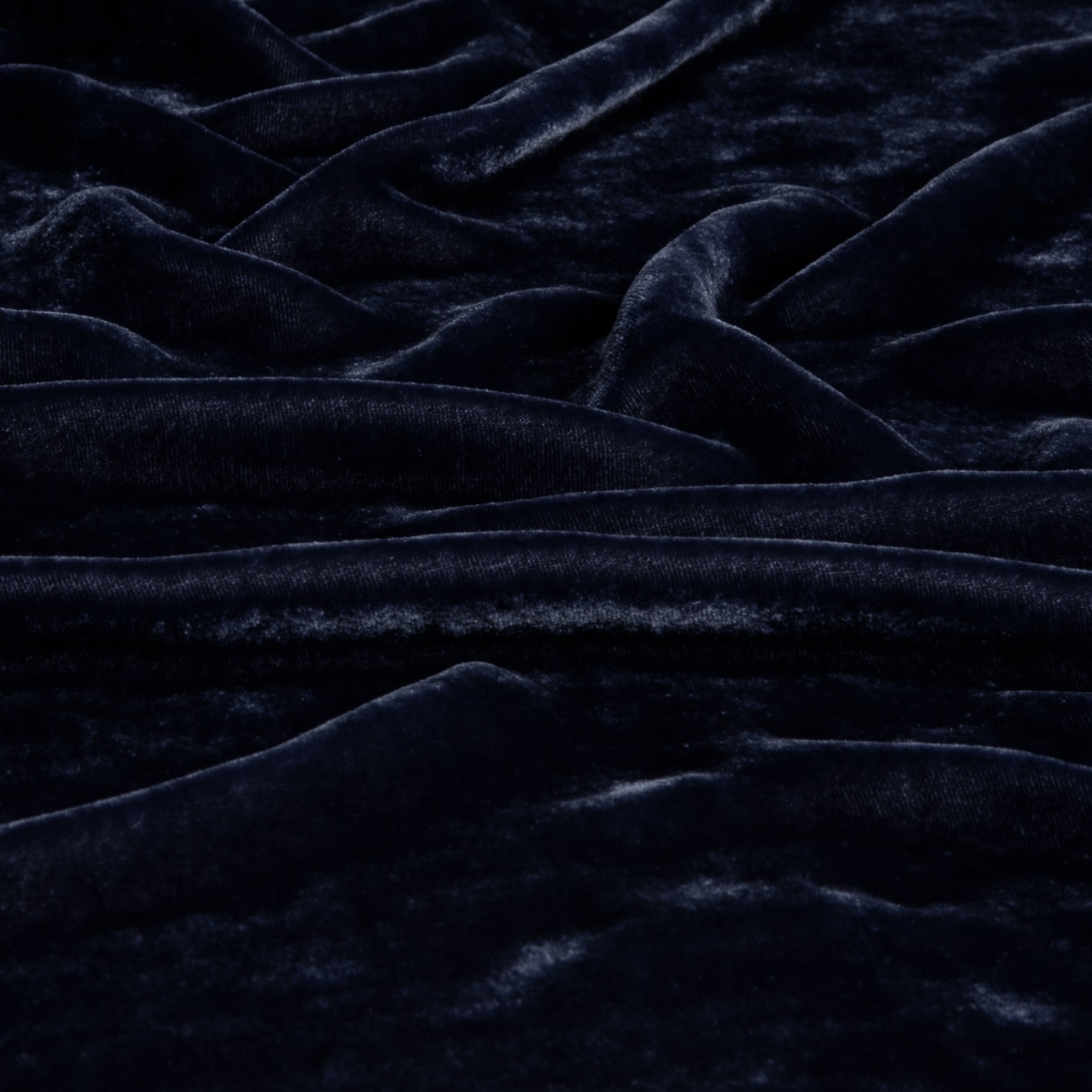 a close up of silk velvet fabric gently rumpled and in french lavender, a purple tone