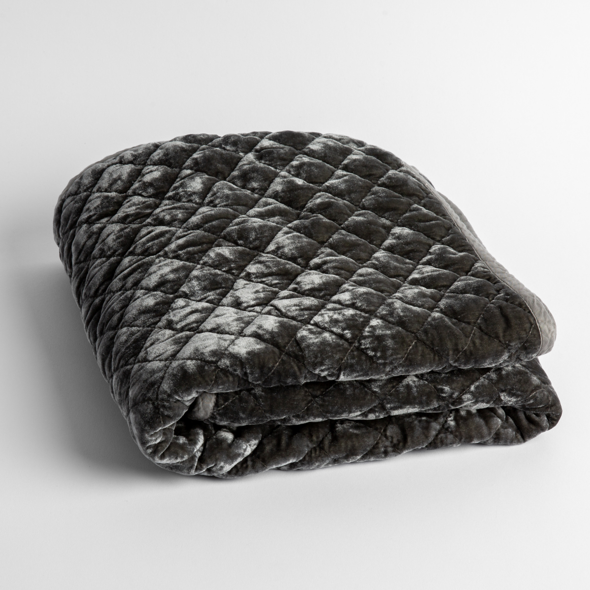Fog: a folded quilted silk velvet baby blanket shown from overhead to showcase quilting pattern and texture.