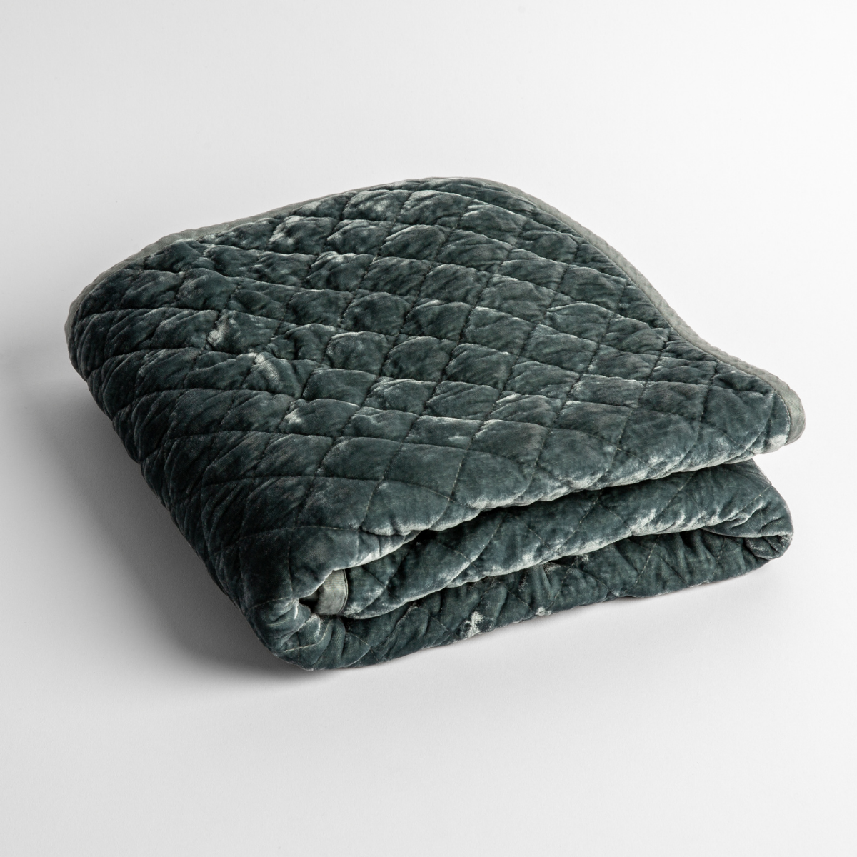 Mineral: a folded quilted silk velvet baby blanket shown from overhead to showcase quilting pattern and texture.