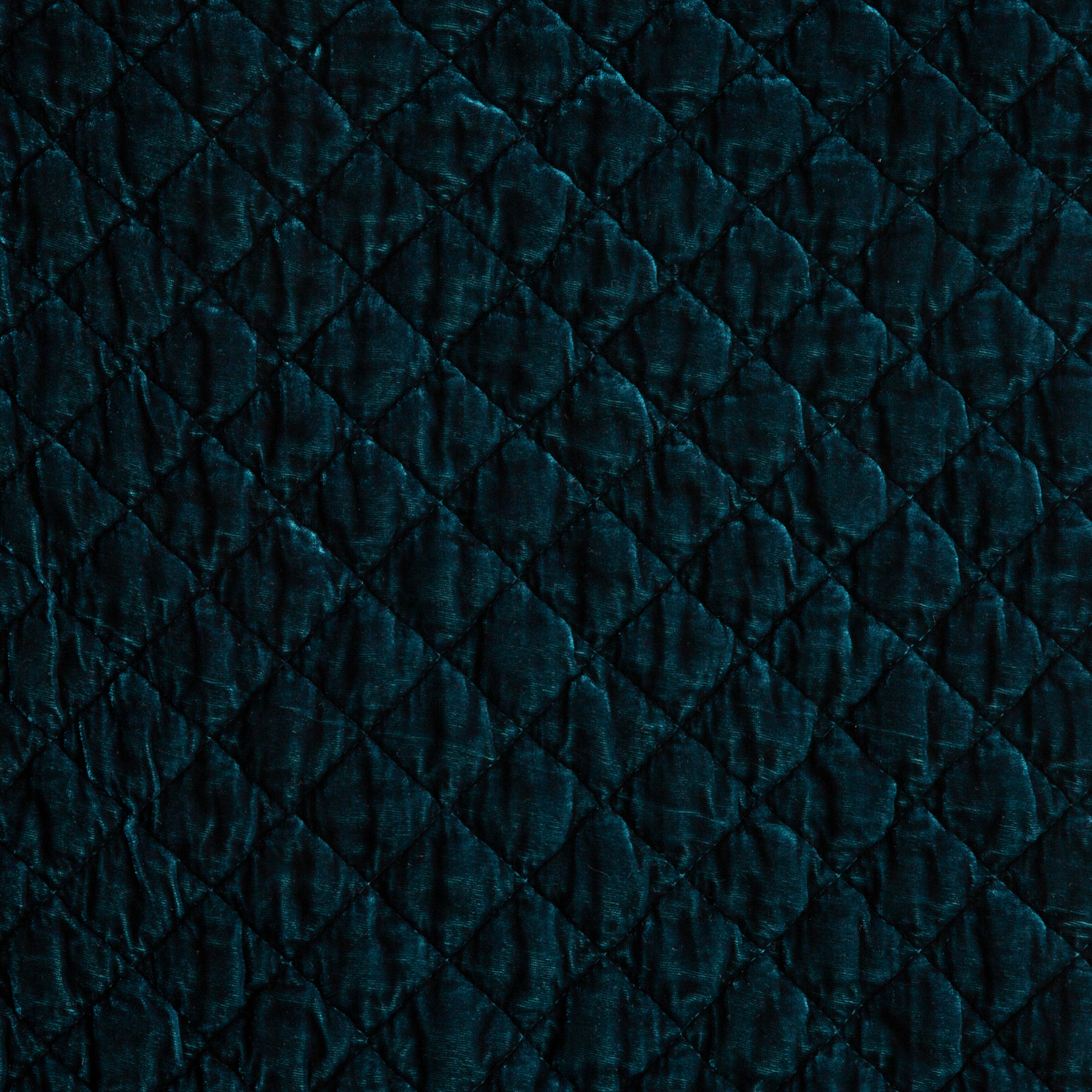 Cenote: A close up of quilted silk velvet fabric in cenote, a vibrant, ocean-inspired blue-green.