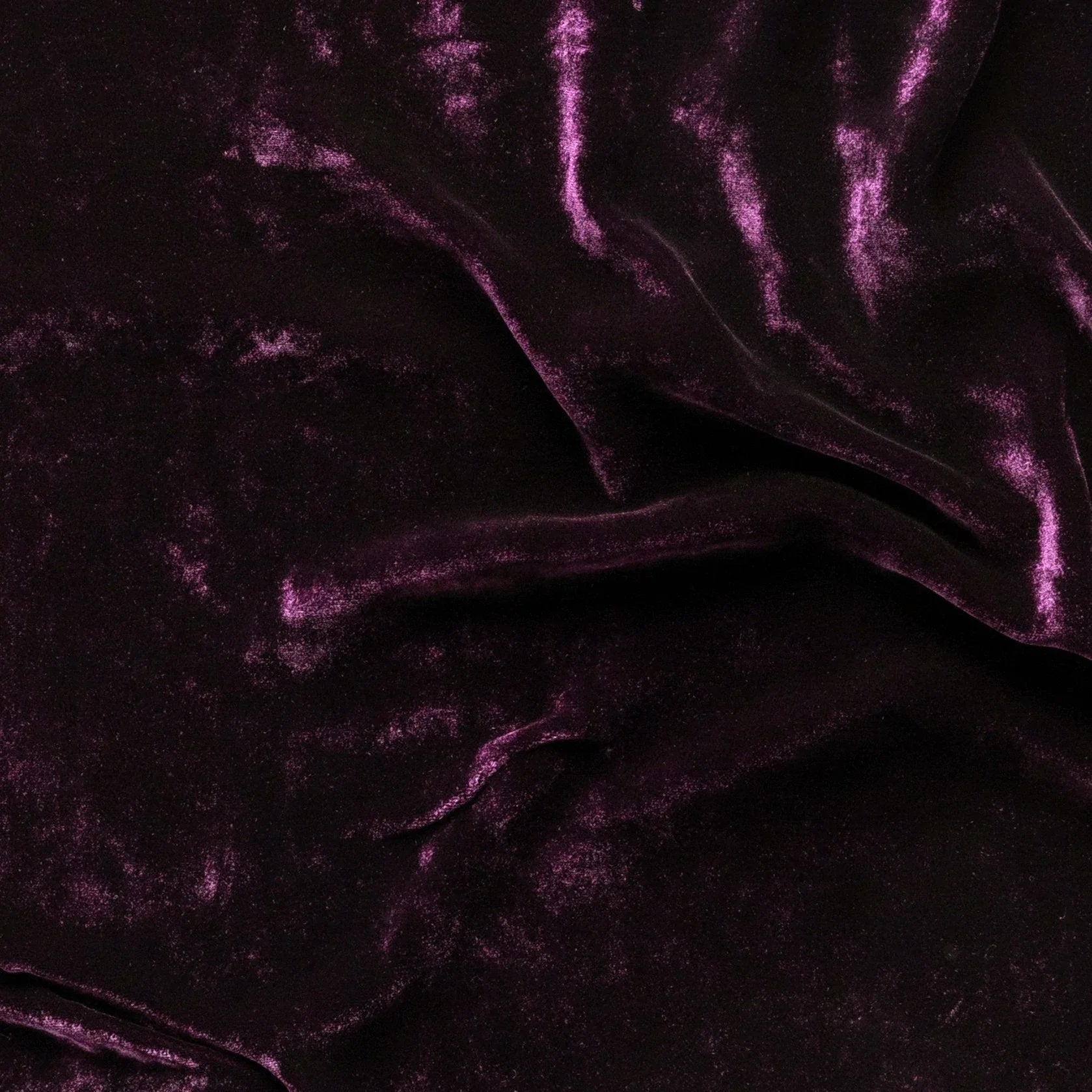 Fig: A close up of silk velvet in fig, a richly saturated purple-garnet.