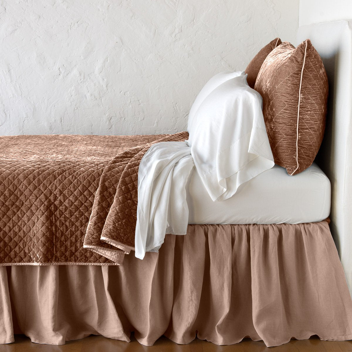 Rouge: coverlet with matching shams and white sheeting - side view.