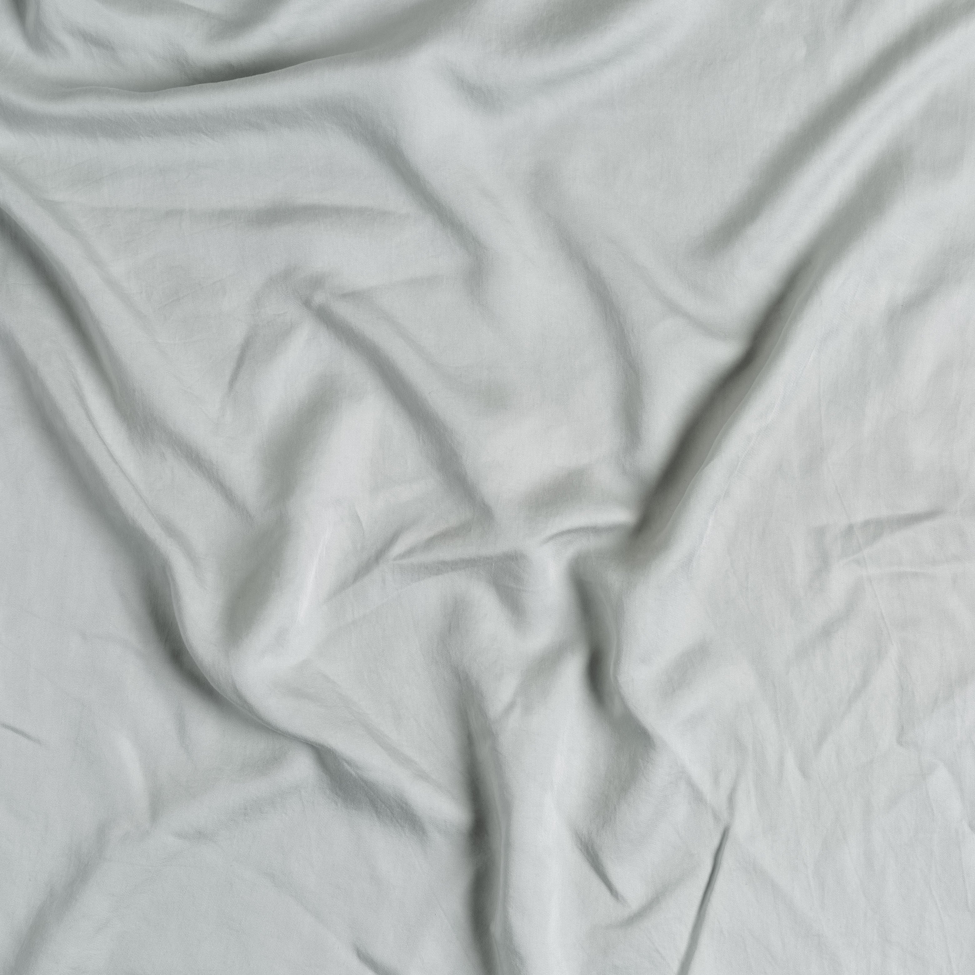 Mineral: A close up of Tencel™ fabric in mineral, a soothing seafoam blue with subtle grey-green undertones.