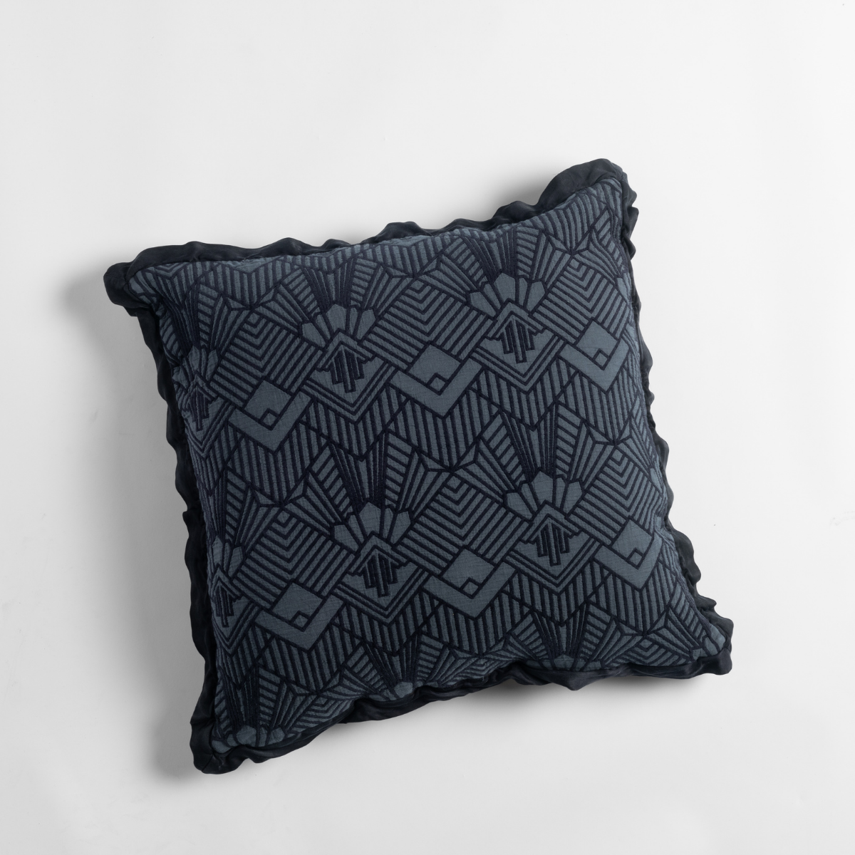 Slate: an overhead shot of a trettino throw pillow against a white background.