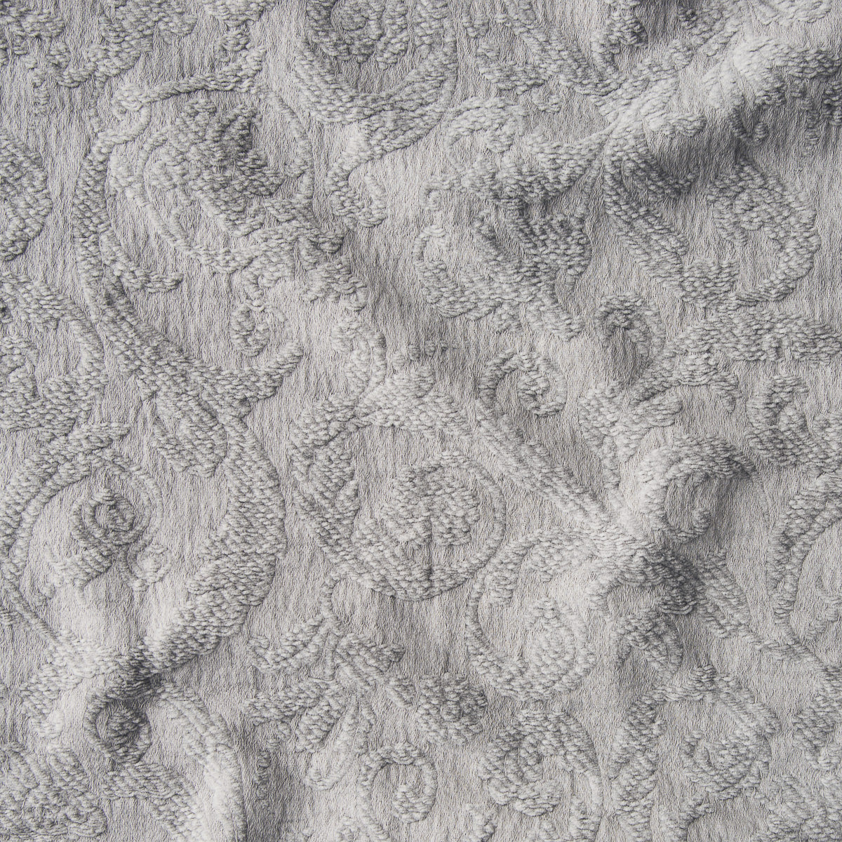Fog: A close up of Adele fabric in fog, a neutral-warm, soft mid-tone grey. The fabric is rumpled to show the cotton damask texture.