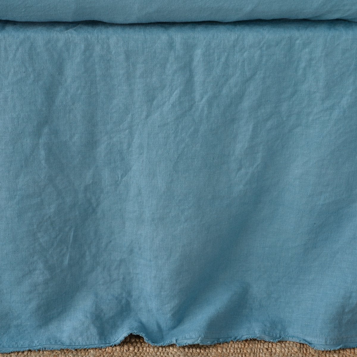 : Close up of the Austin bed skirt in cenote, highlighting its tailored, ungathered style.