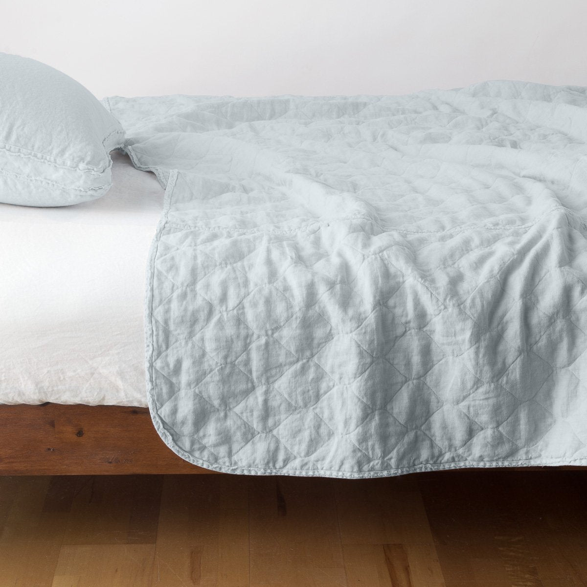 Cloud: quilted midweight linen coverlet on a bed - side view.