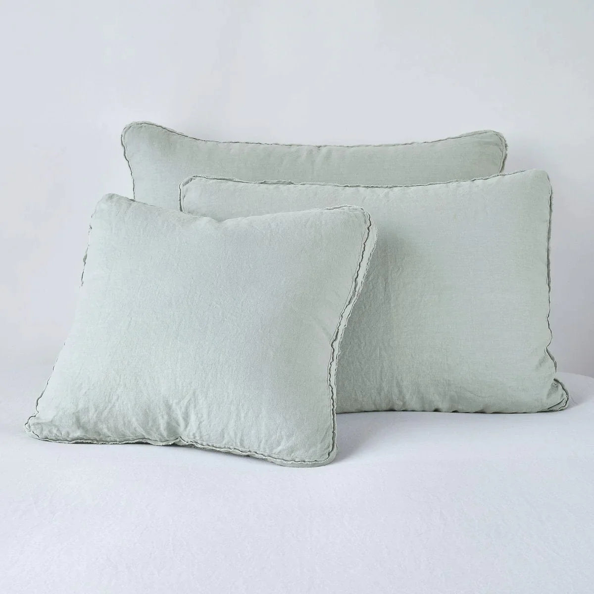 Eucalyptus: Midweight linen shams in eucalyptus colorway shown leaning upright on white background.