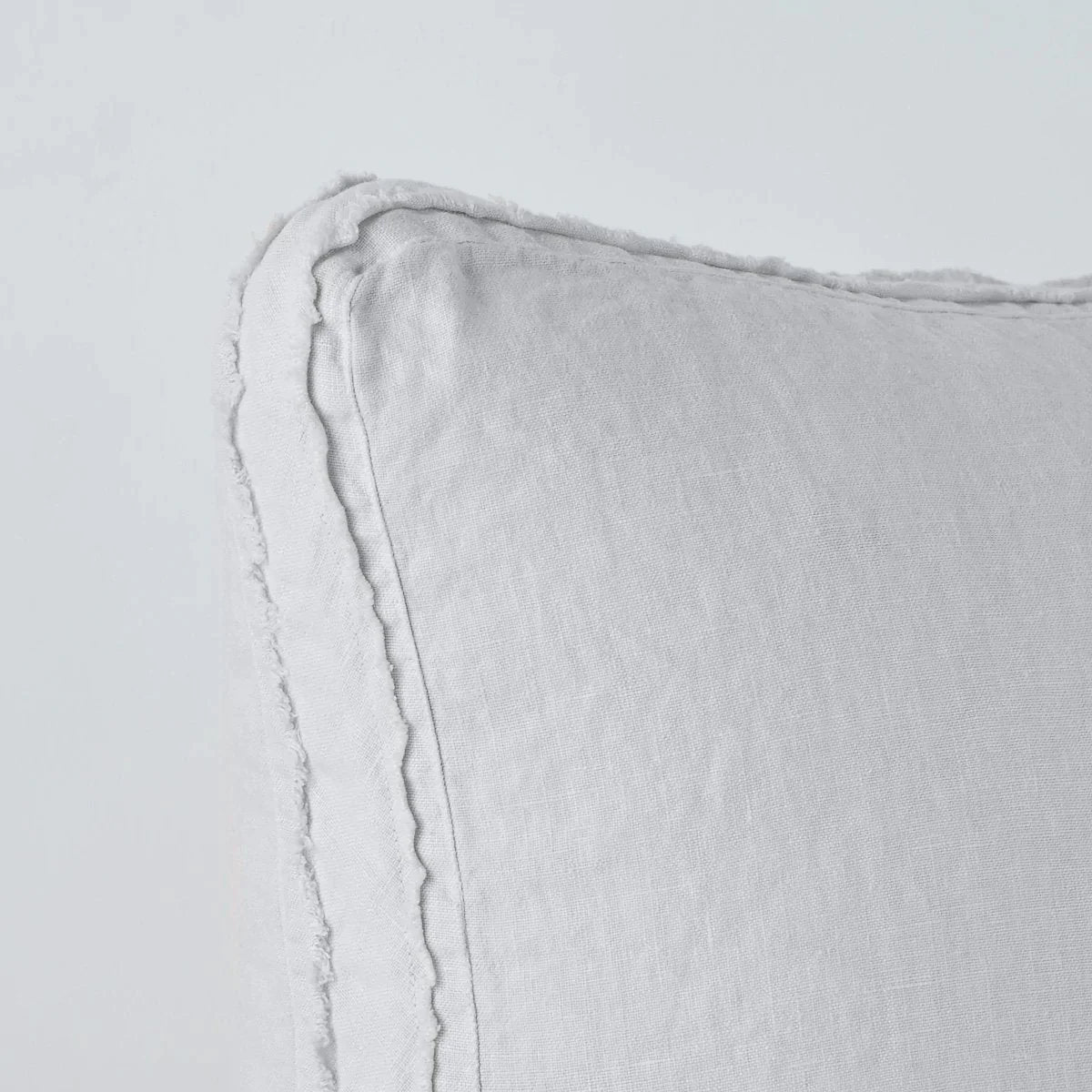 Sterling: Close-up angle of the corner of an Austin sham, highlighting the raw edge trim on either side of the gusset.