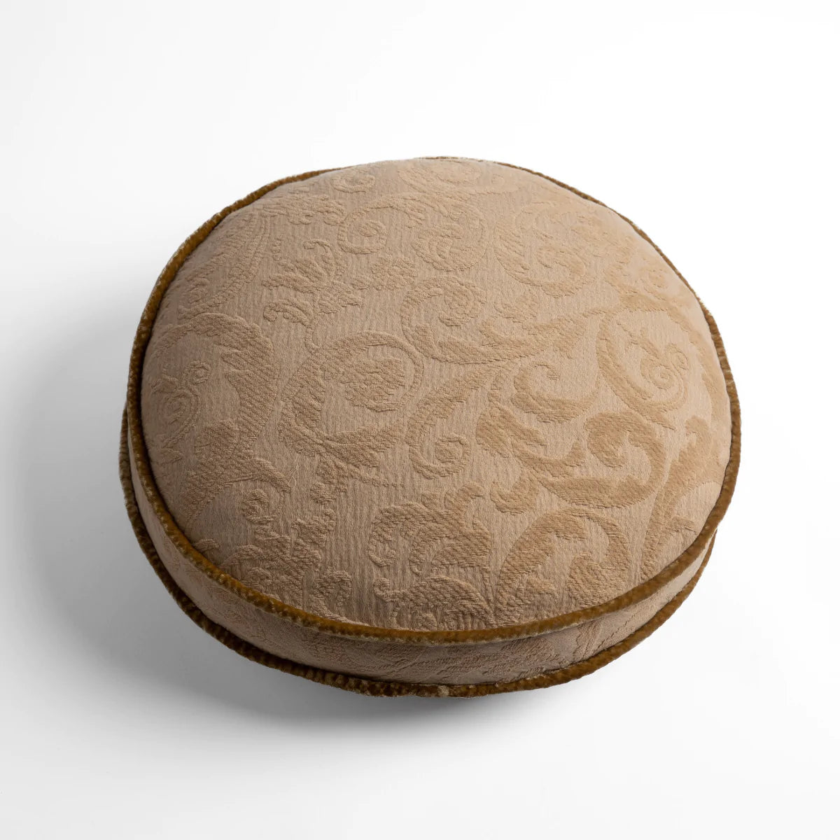 Honeycomb: Organic cotton damask round pillow with silk velvet trim on white background β overhead angle.