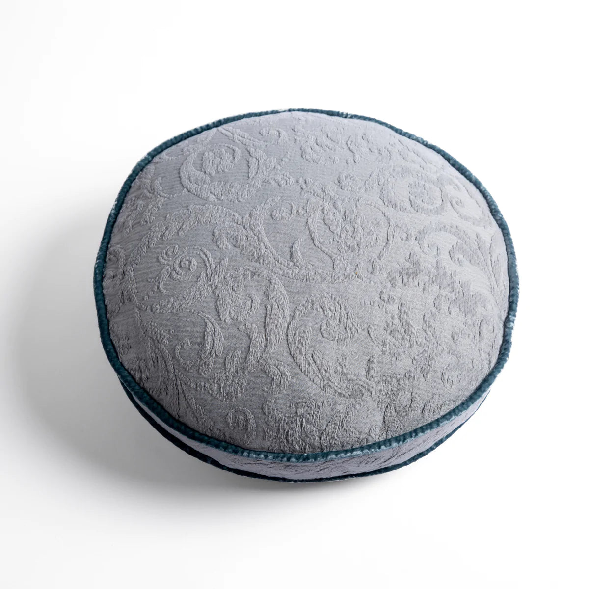 Mineral: Organic cotton damask round pillow with silk velvet trim on white background β overhead angle.