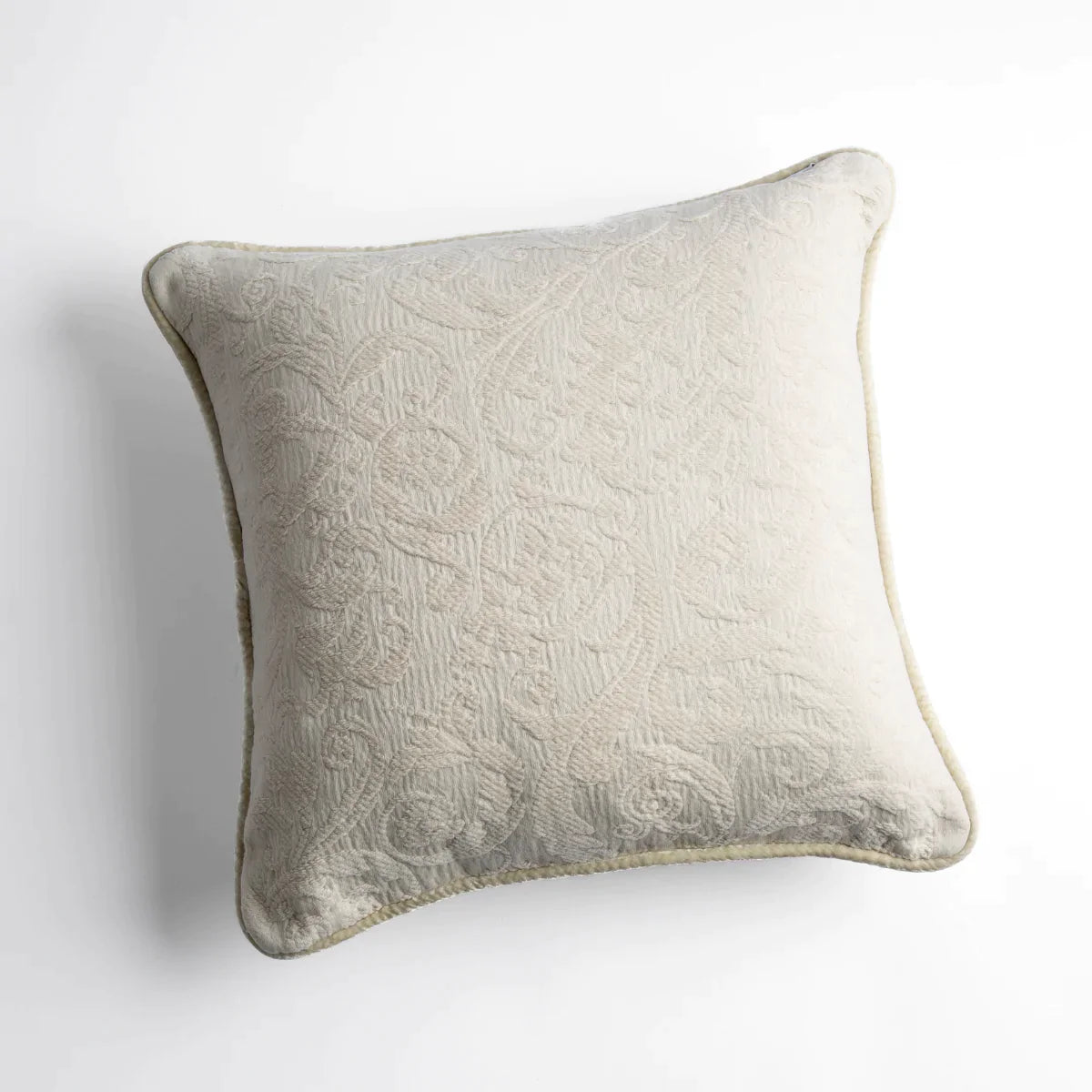 Parchment: Organic cotton damask square pillow with silk velvet trim on white background β overhead angle.