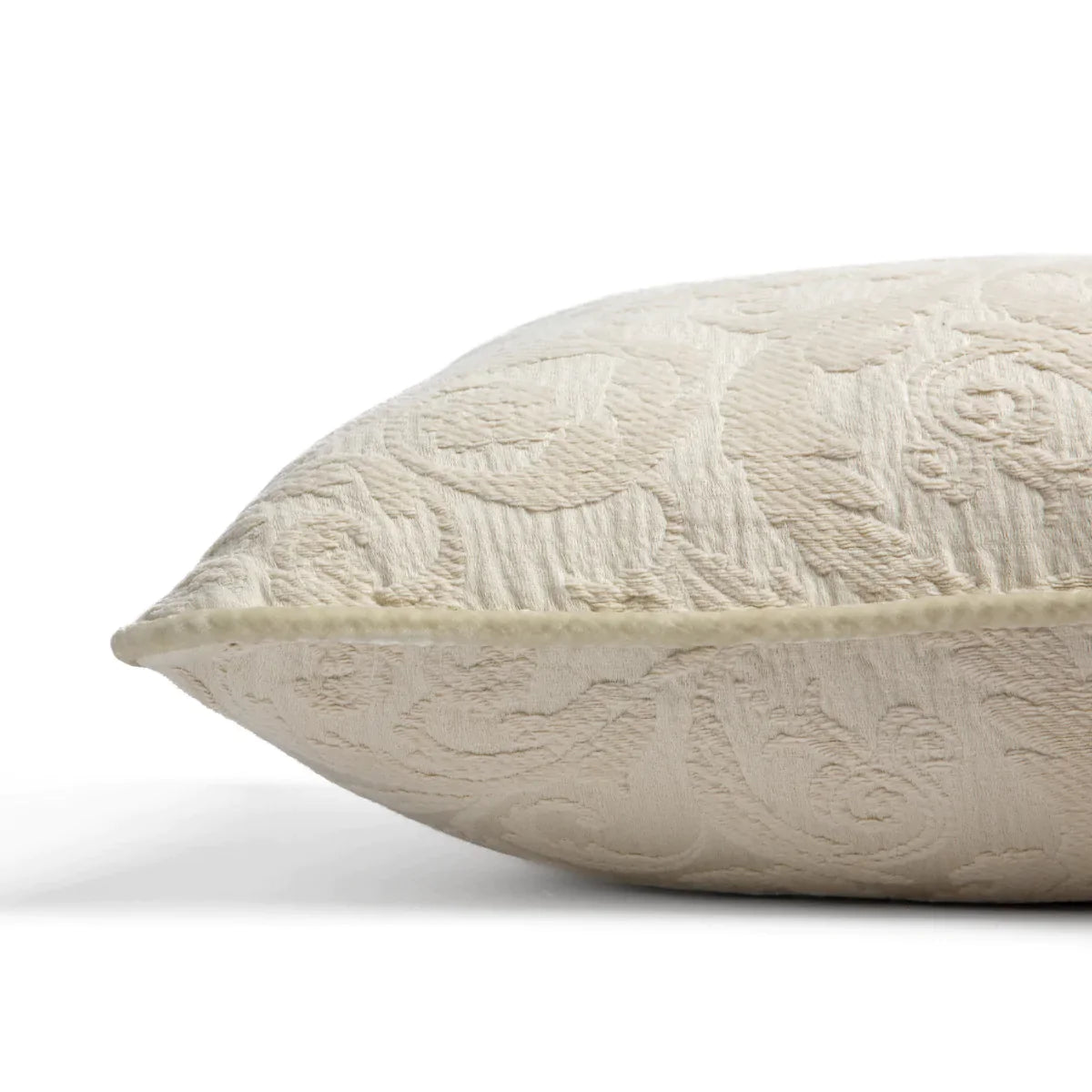 Parchment: Organic cotton damask square pillow with silk velvet trim on white background β side angle.