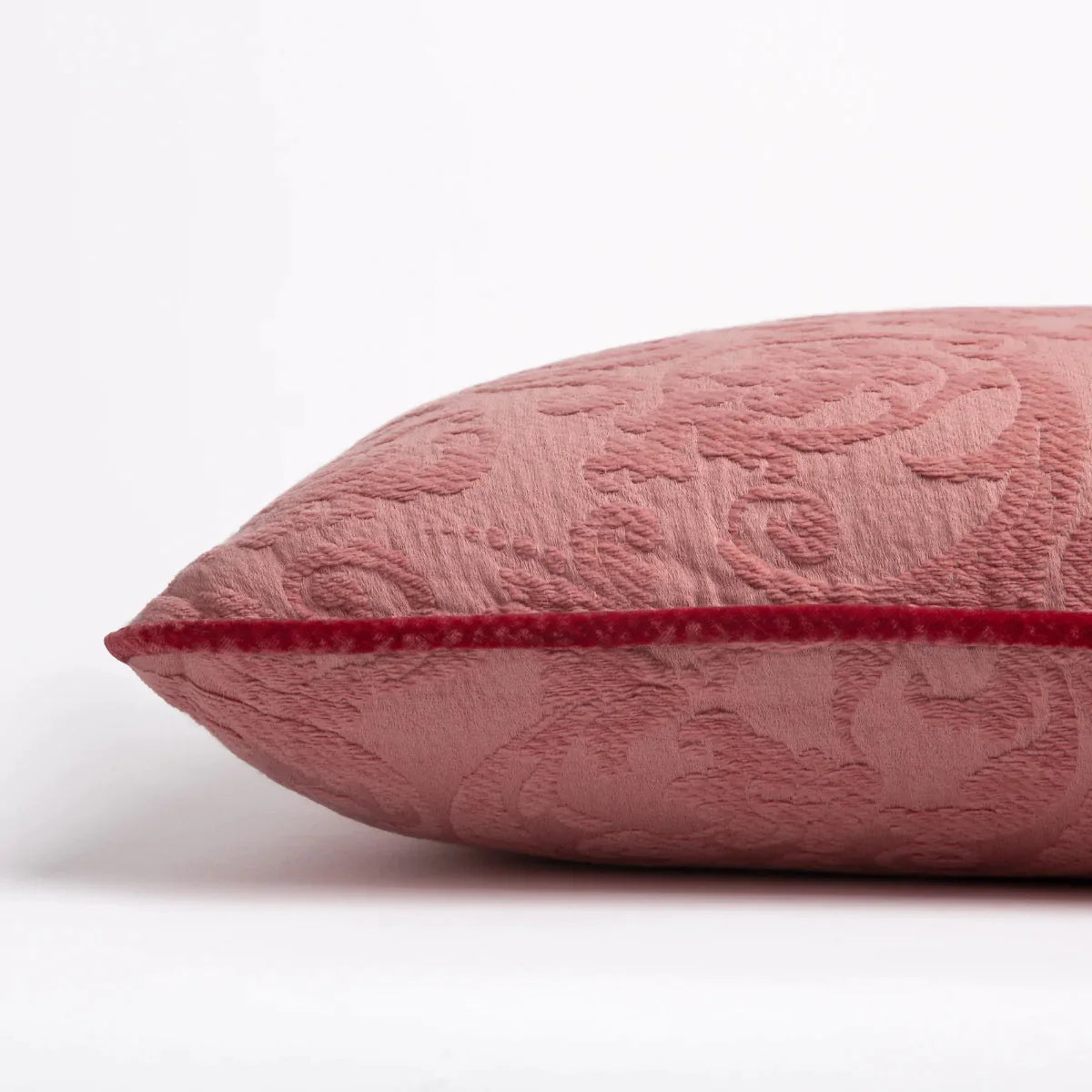 Poppy: Organic cotton damask square pillow with silk velvet trim on white background β side angle.