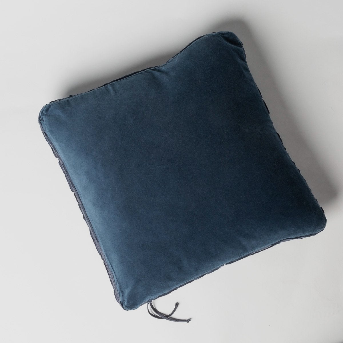 Midnight: Cotton velvet 24 by 24 pillow on a plain background - overhead view.