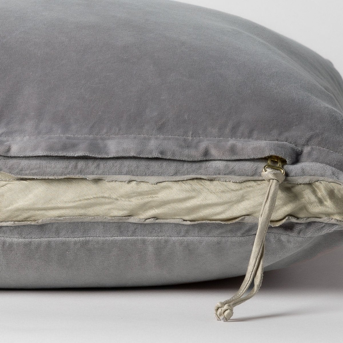 Moonlight: Close-up of charmeuse gusset, raw-edge trim, and brass zipper detail on cotton velvet sham - side view.