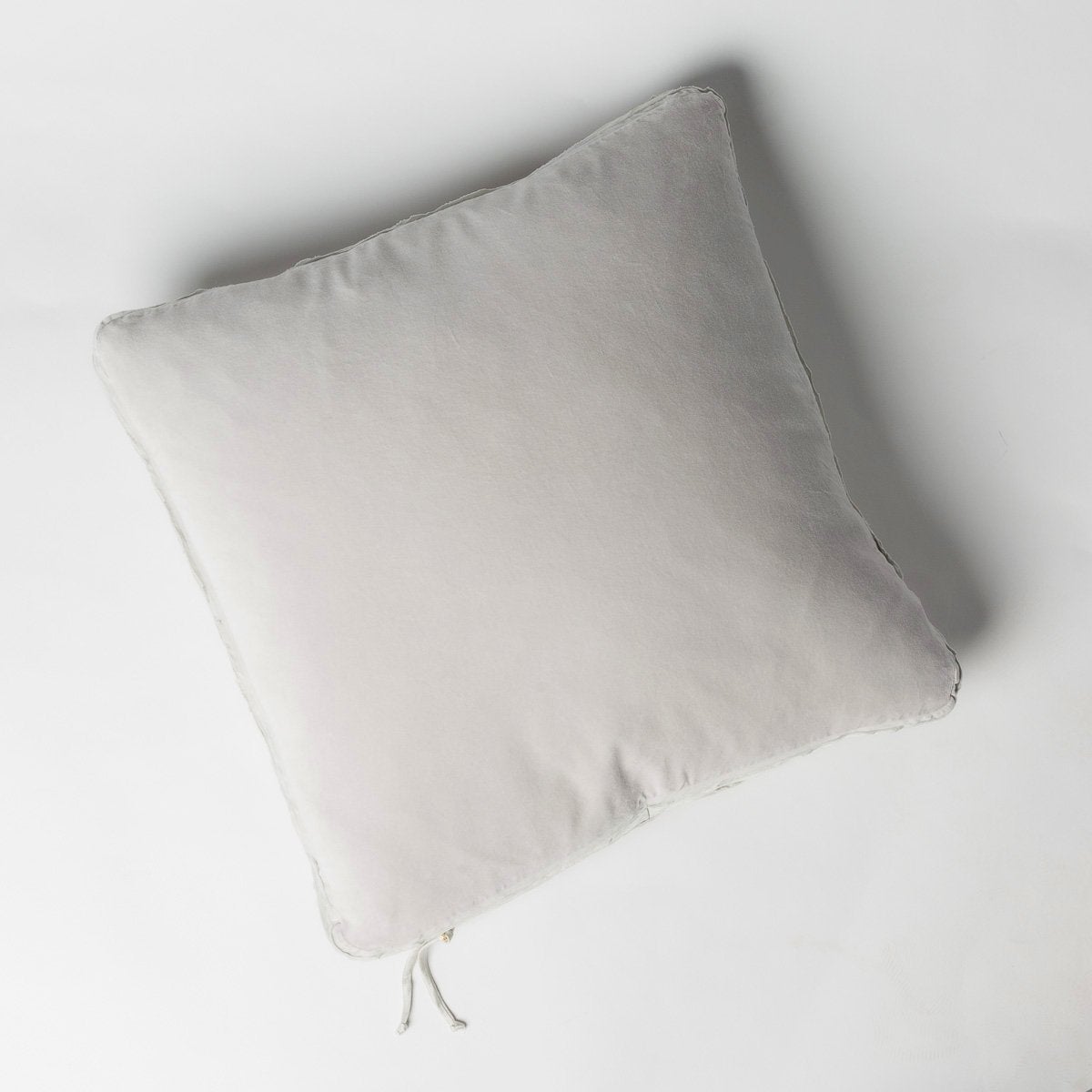Sterling: Cotton velvet 24 by 24 pillow on a plain background - overhead view.