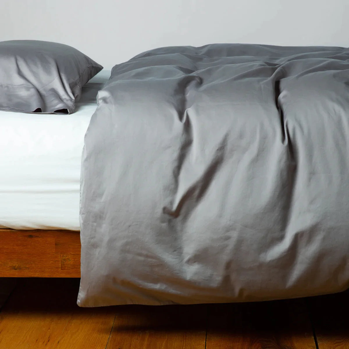 Moonlight: duvet cover and matching sleeping pillow on white sheeting - side view.