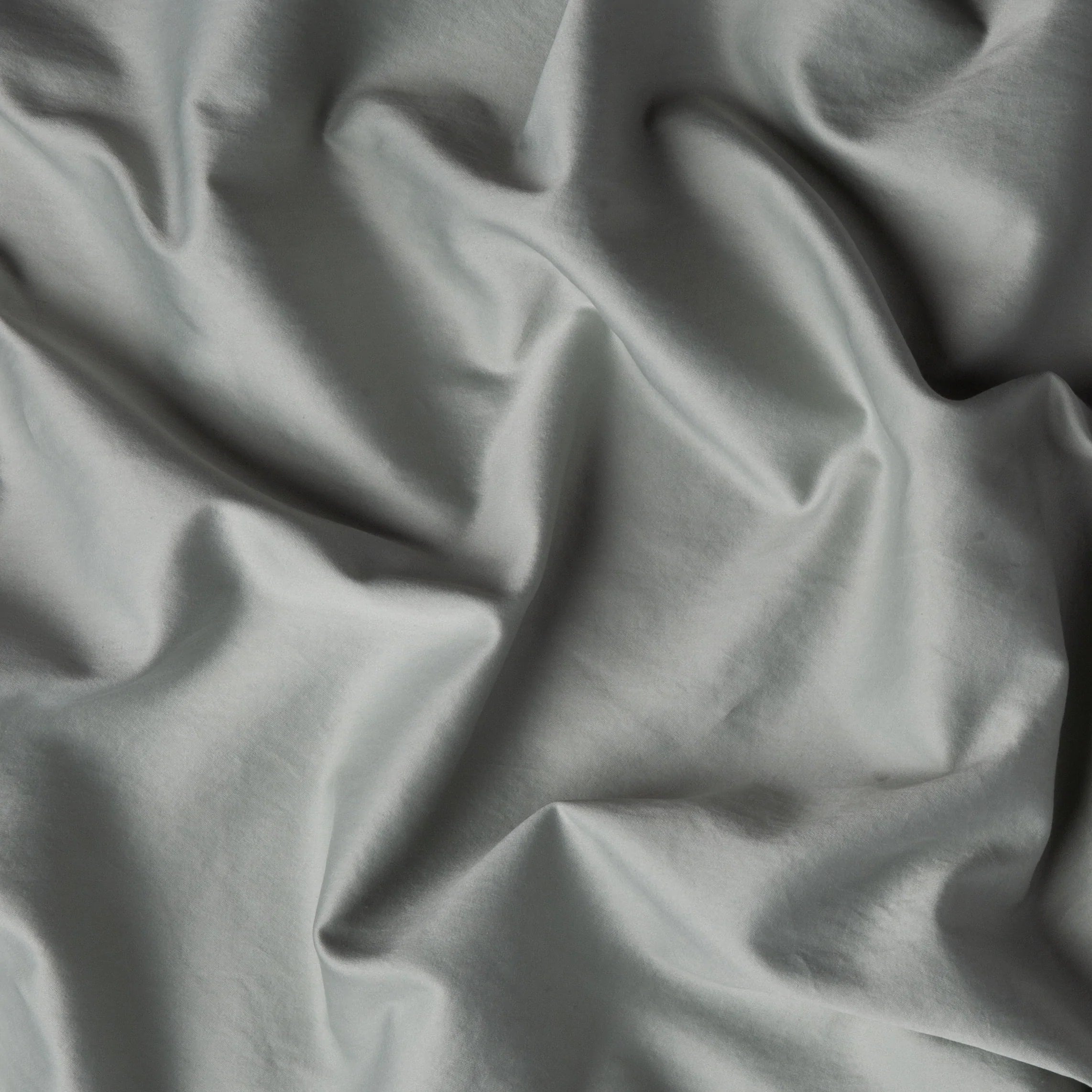 Eucalyptus: A close up of cotton sateen fabric in eucalyptus, a soft light green.