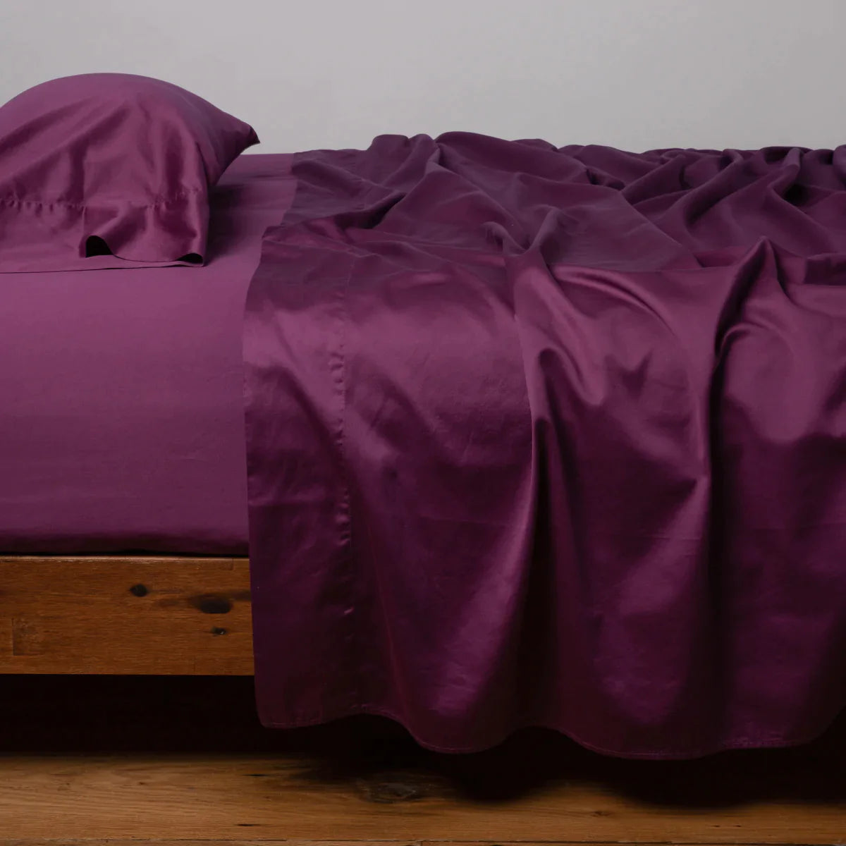 Fig: Cotton sateen fitted sheet shown with matching flat sheet and sleeping pillow - side view.