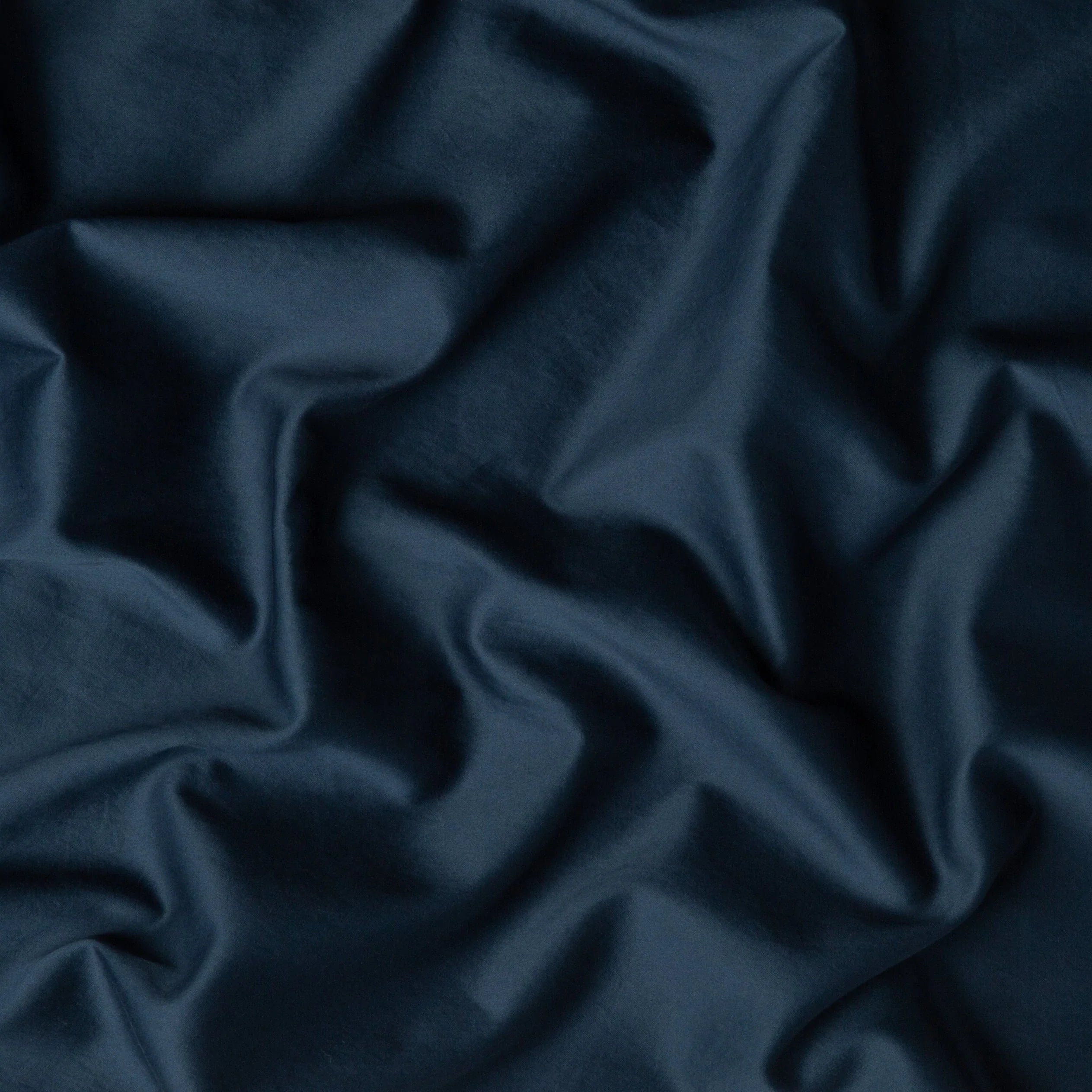 Midnight: A close up of cotton sateen fabric in midnight, a rich indigo tone.