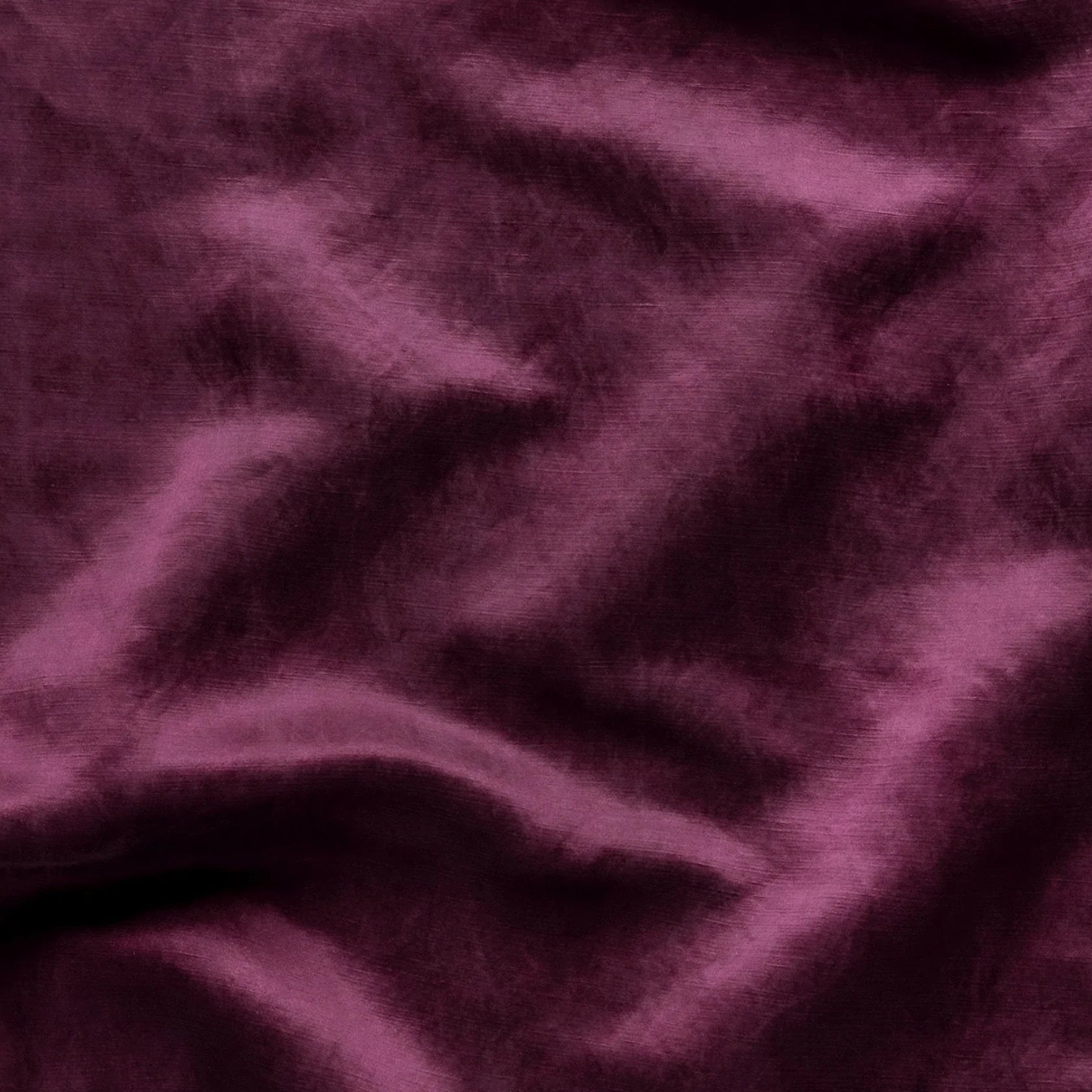 Fig: Close-up of silk charmeuse in fig, a richly saturated purple-garnet.