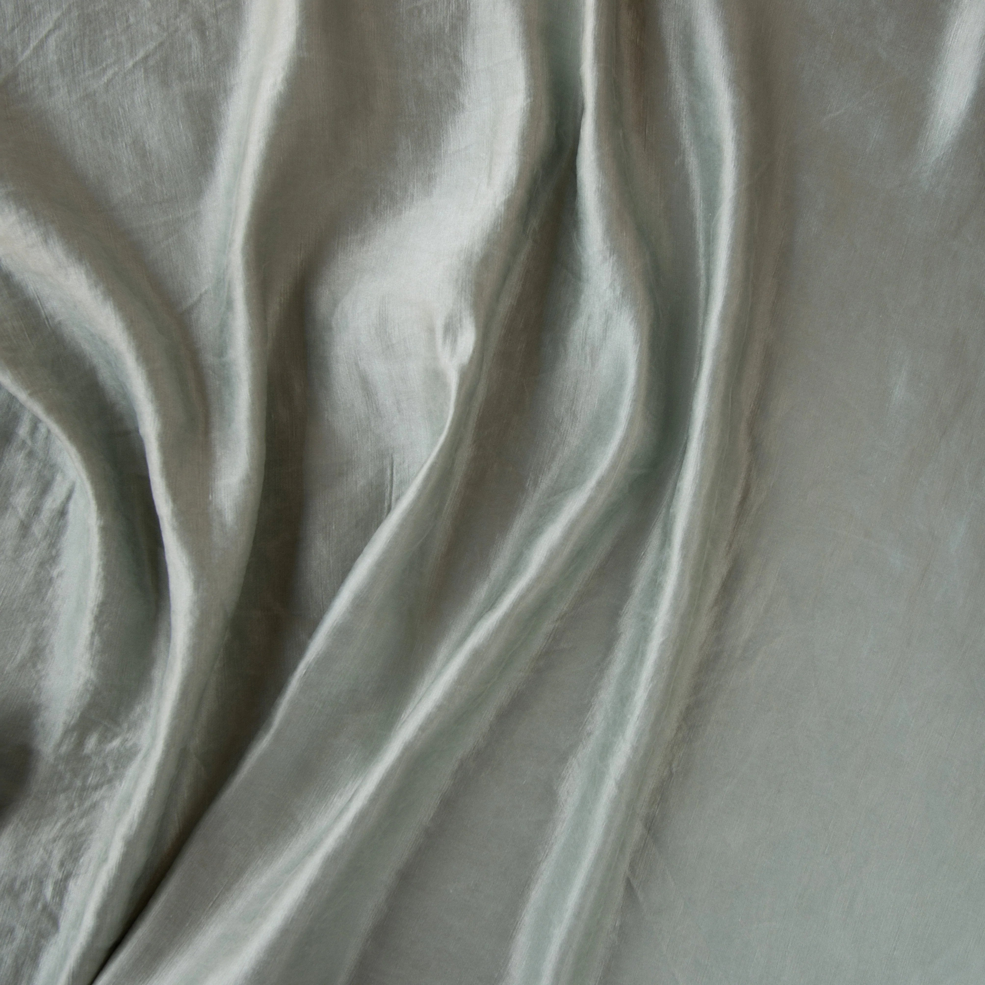 Mineral: Close-up of silk charmeuse in mineral, a soothing seafoam blue with subtle grey-green undertones.