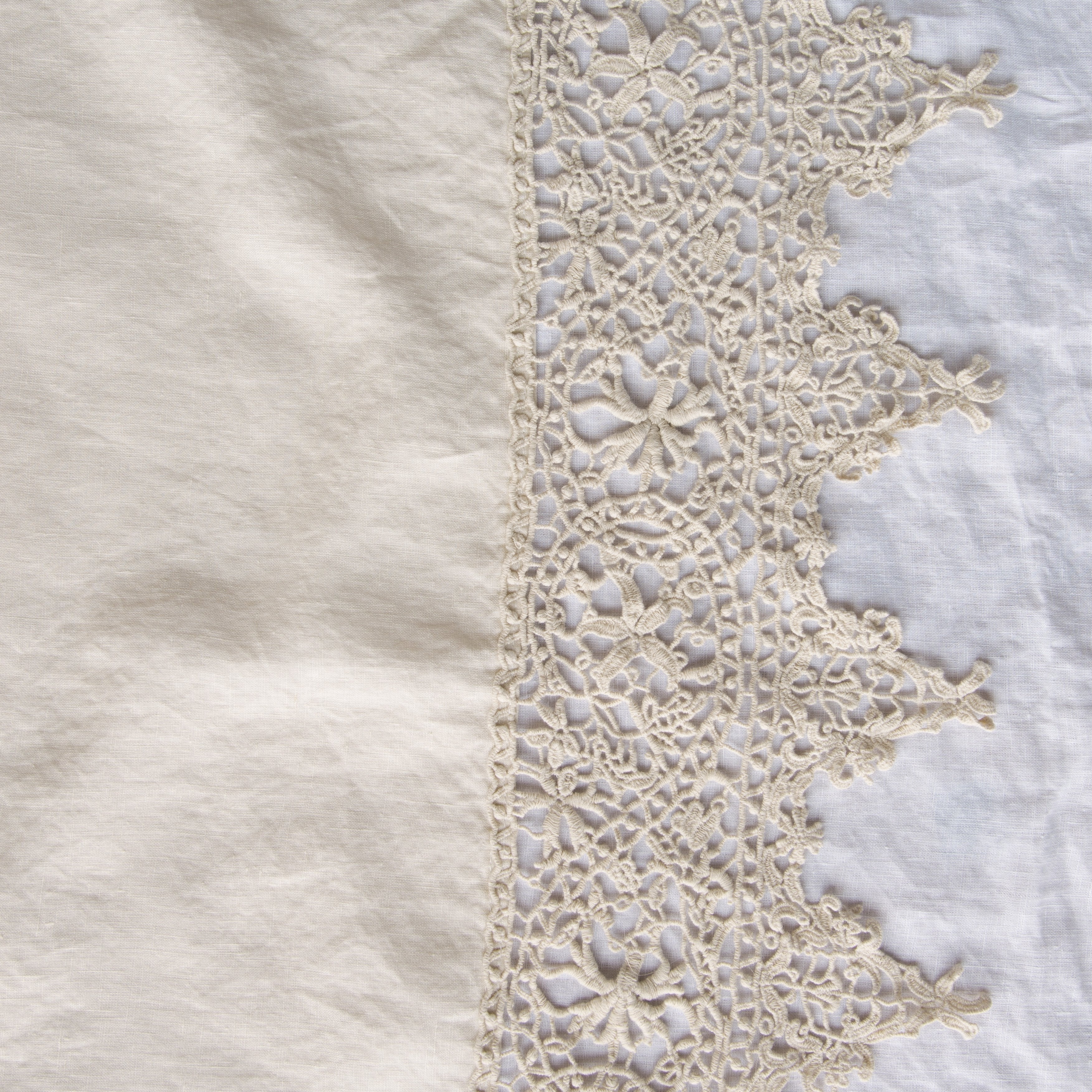 Parchment: A close up of Frida, an antique cotton lace trim on a linen body, shown in parchment, a warm, antiqued cream.