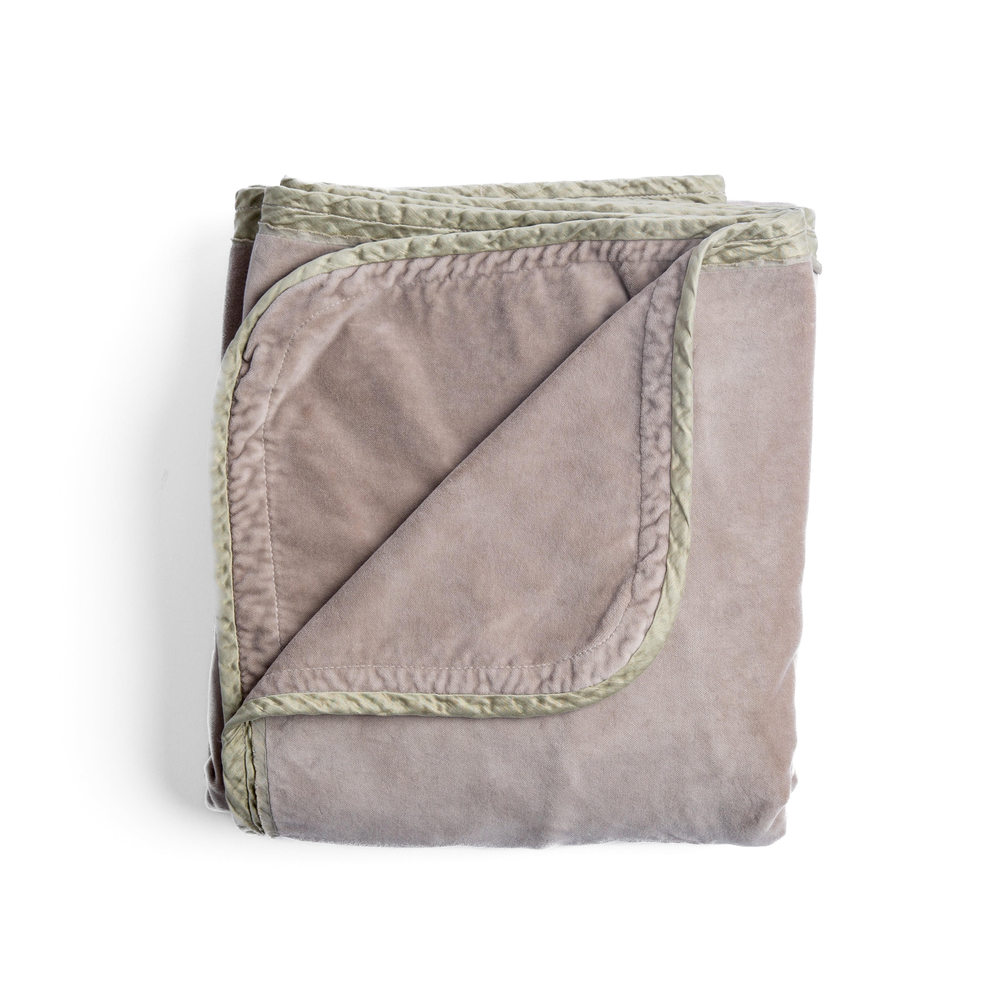 Fog: overhead angle of the folded blanket with a corner pulled back to show the reverse and trim.