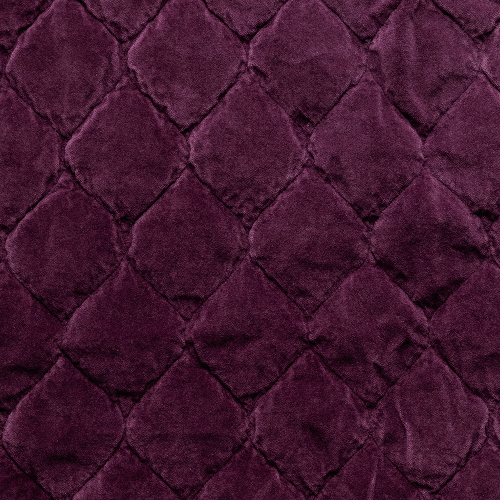 Fig: Close-up of Harlow cotton velvet quilting in fig, a richly saturated purple-garnet.