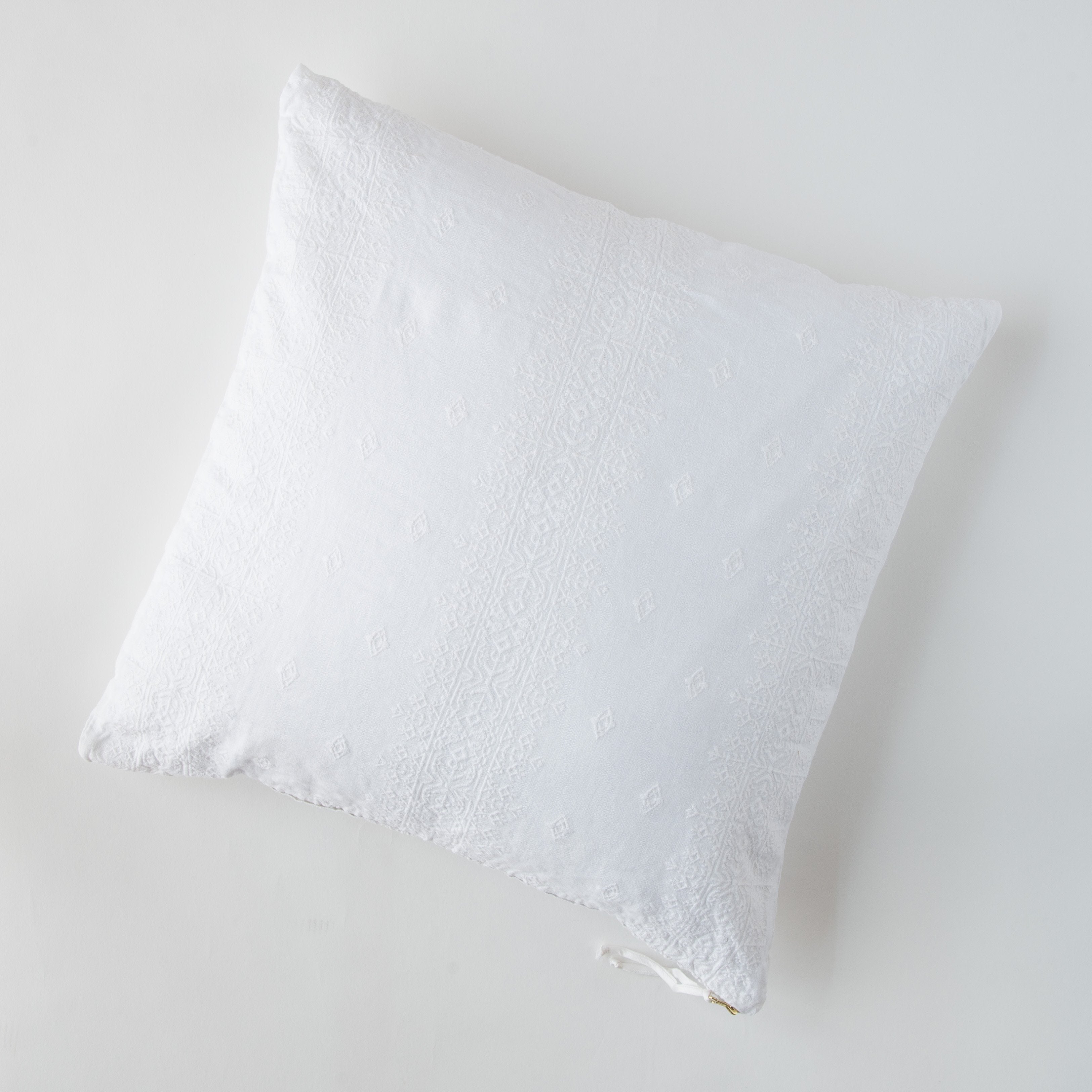 White: pillow on a white background - overhead view.