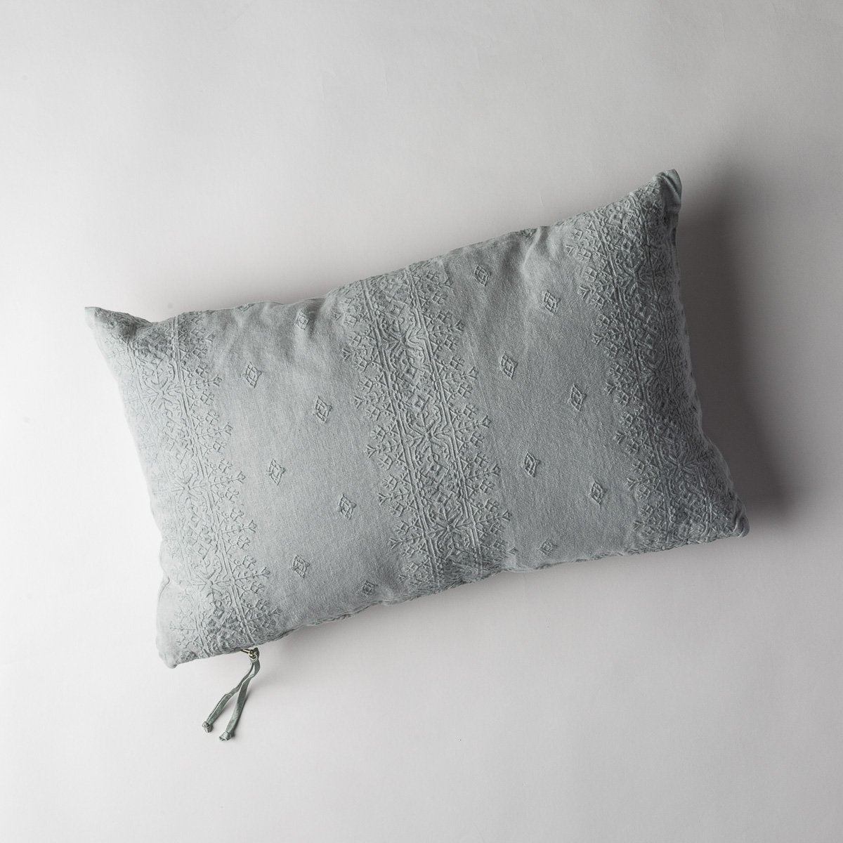 Eucalyptus: embroidered midweight linen 15x24 pilow overhead on a white background.