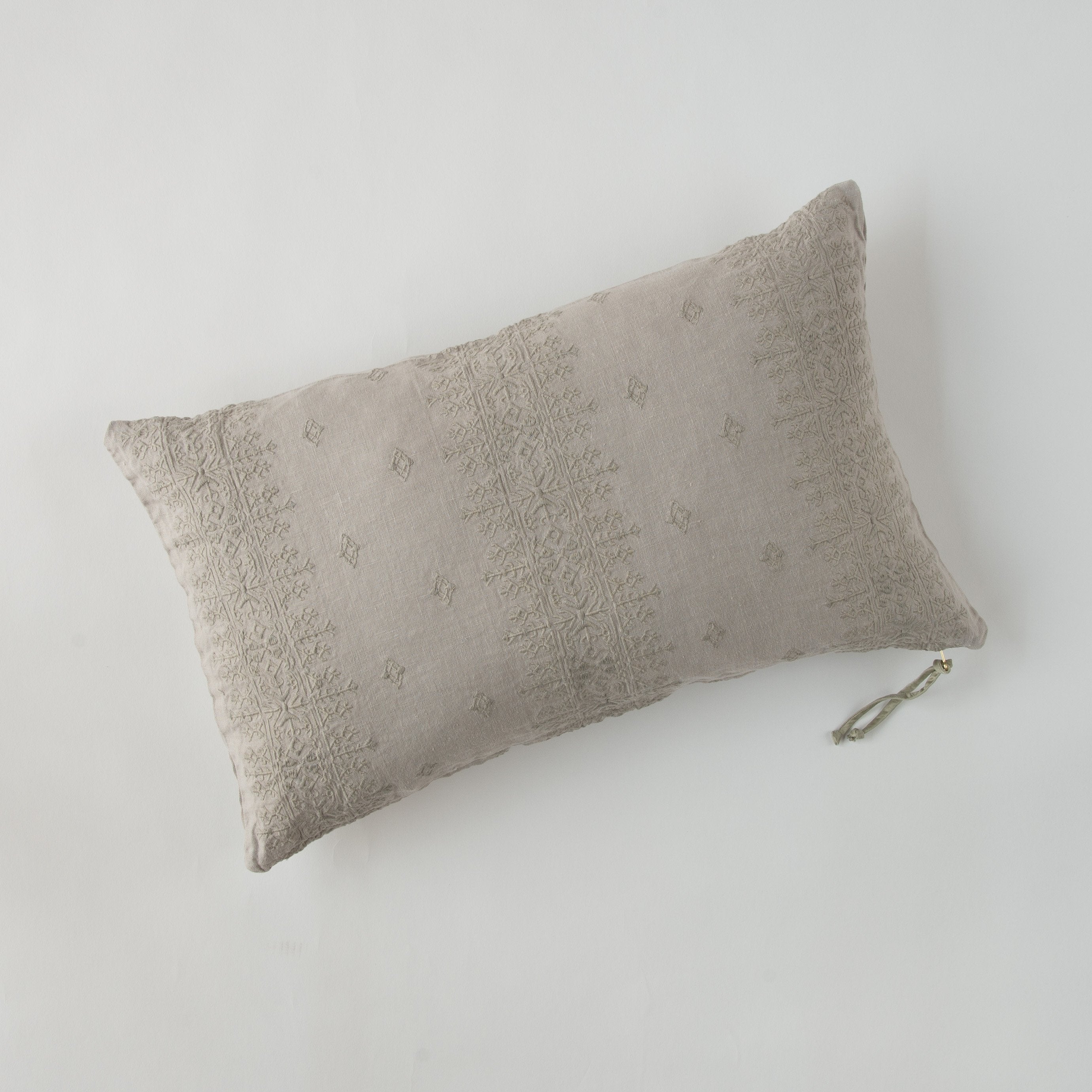 Fog: embroidered midweight linen 15x24 pilow overhead on a white background.