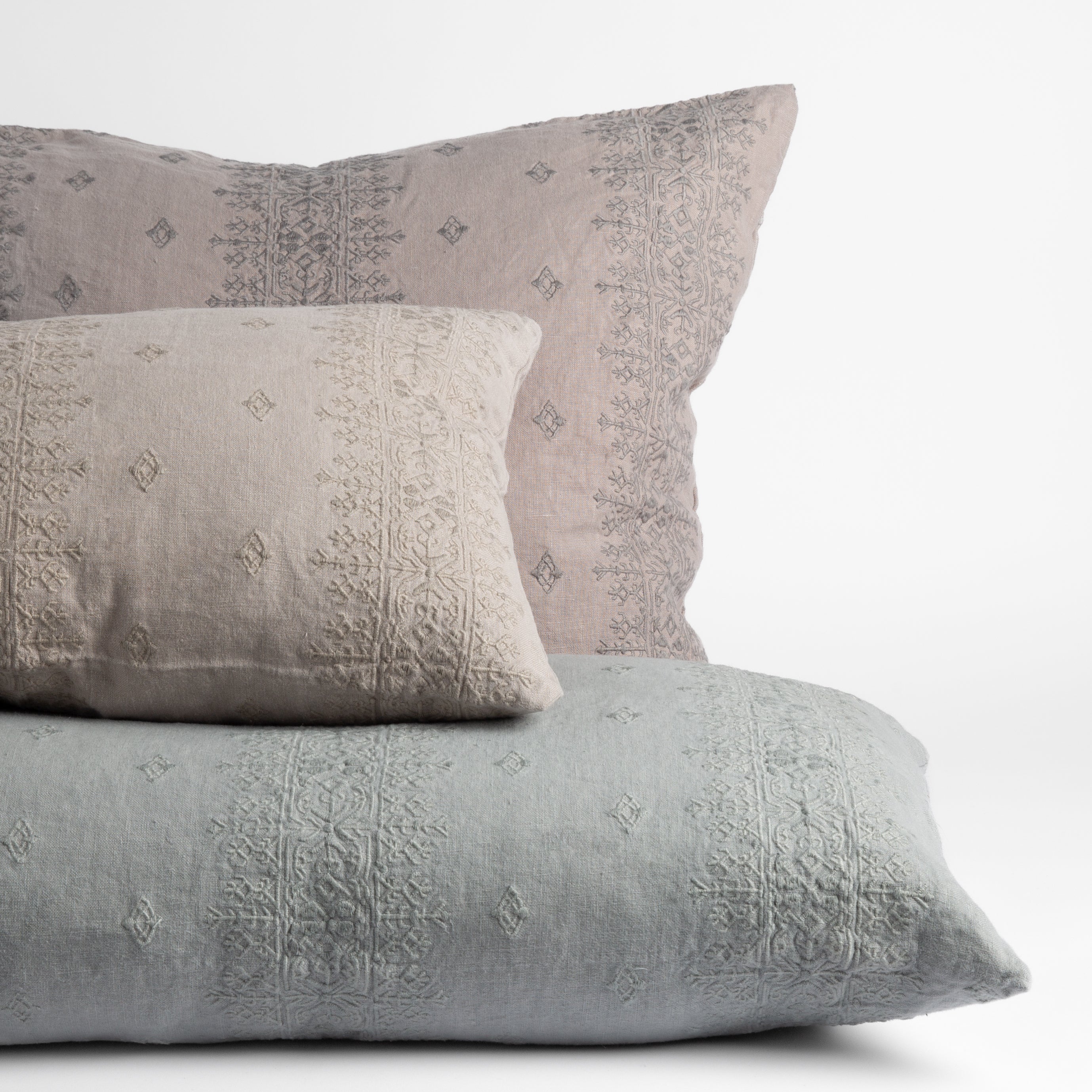 : embroidered midweight linen throw pillows straight on against a white background.