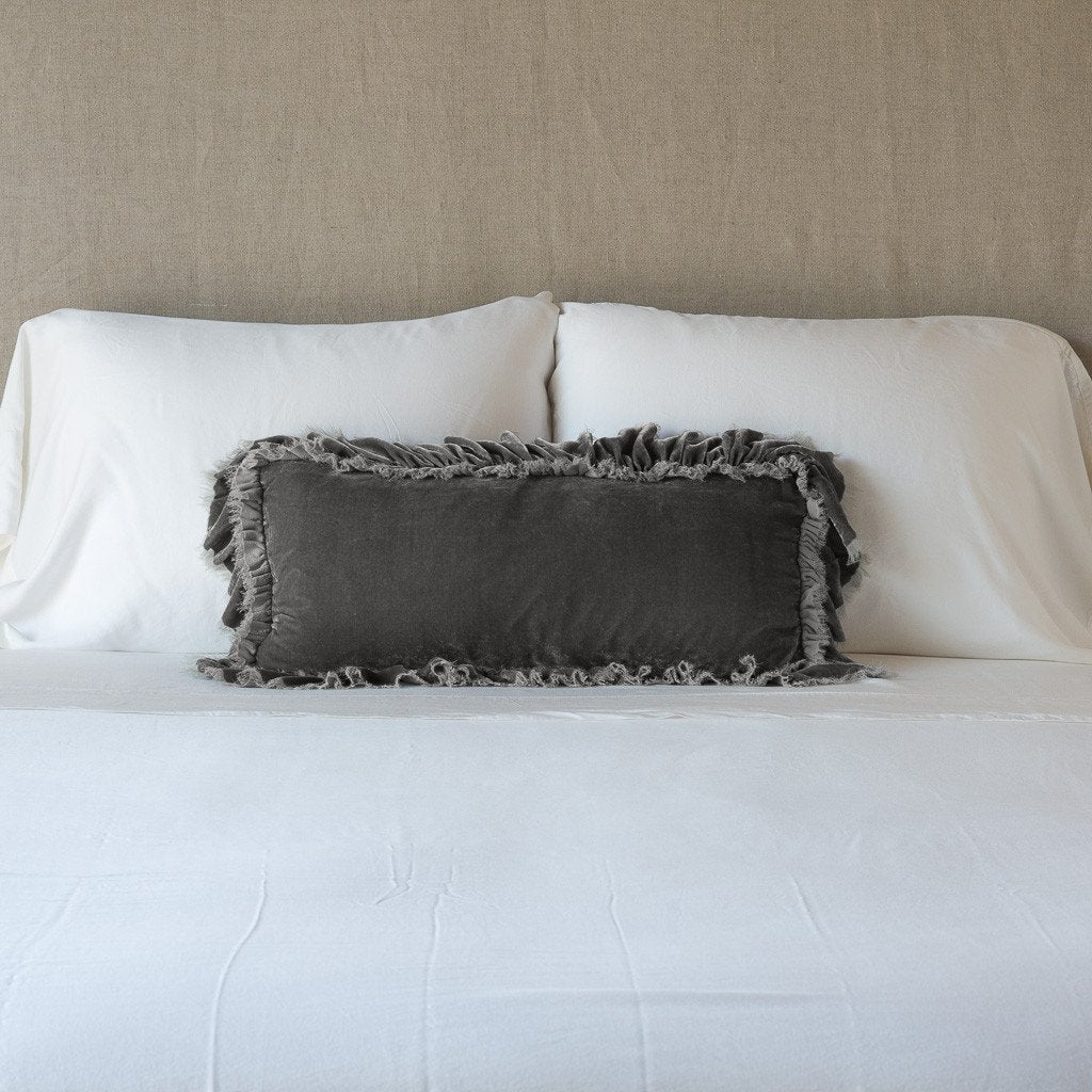 Fog: pillow on a white bed - cropped end of bed view.