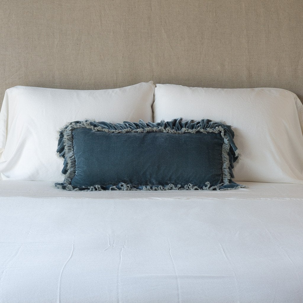 Mineral: pillow on a white bed - cropped end of bed view.