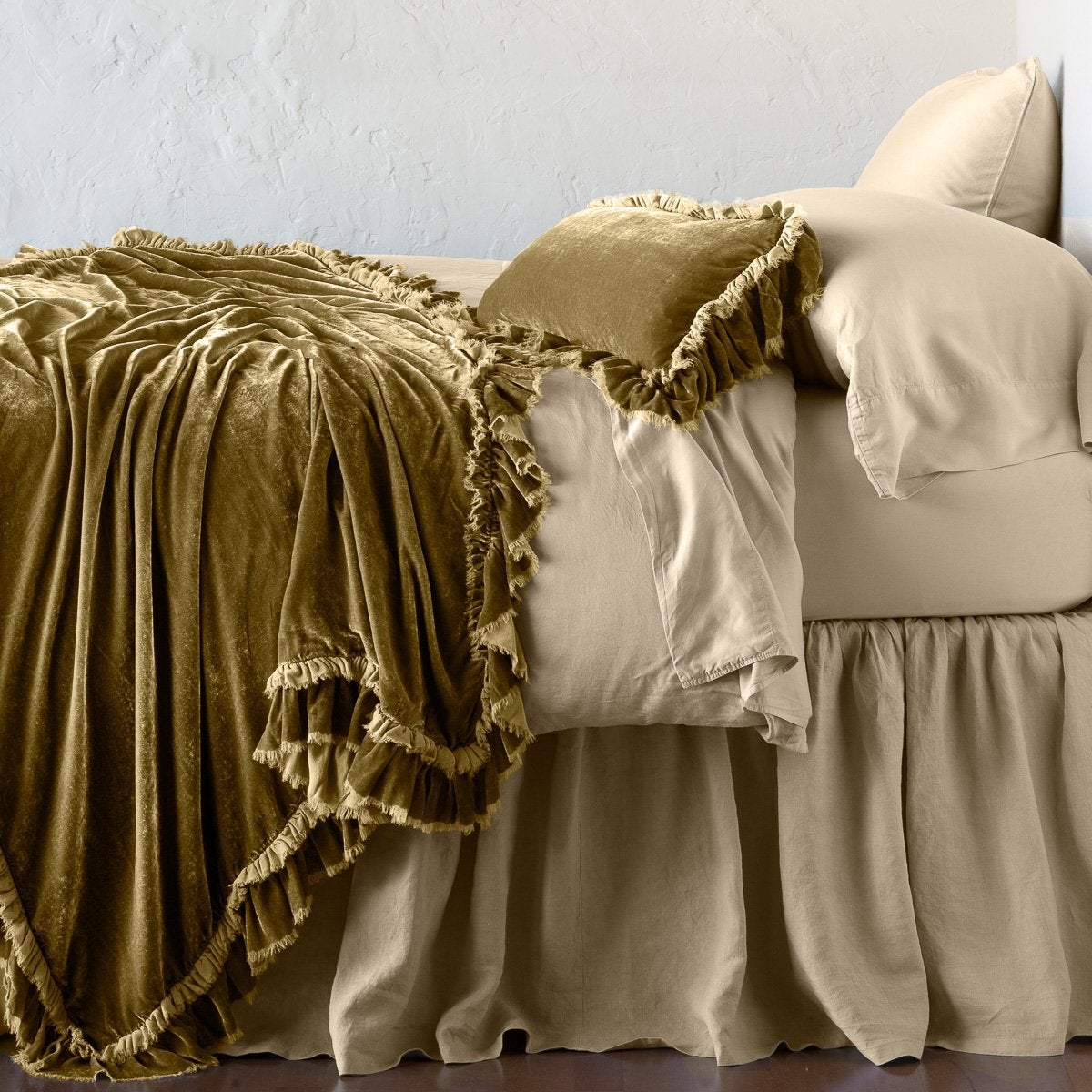 Honeycomb: throw blanket draped over a monochromatic bed, shown with matching throw pillow - side view.