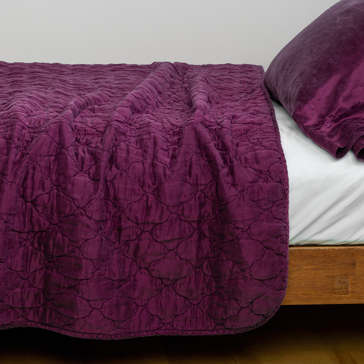 Fig: coverlet with charmeuse pillow on white sheeting - side view.