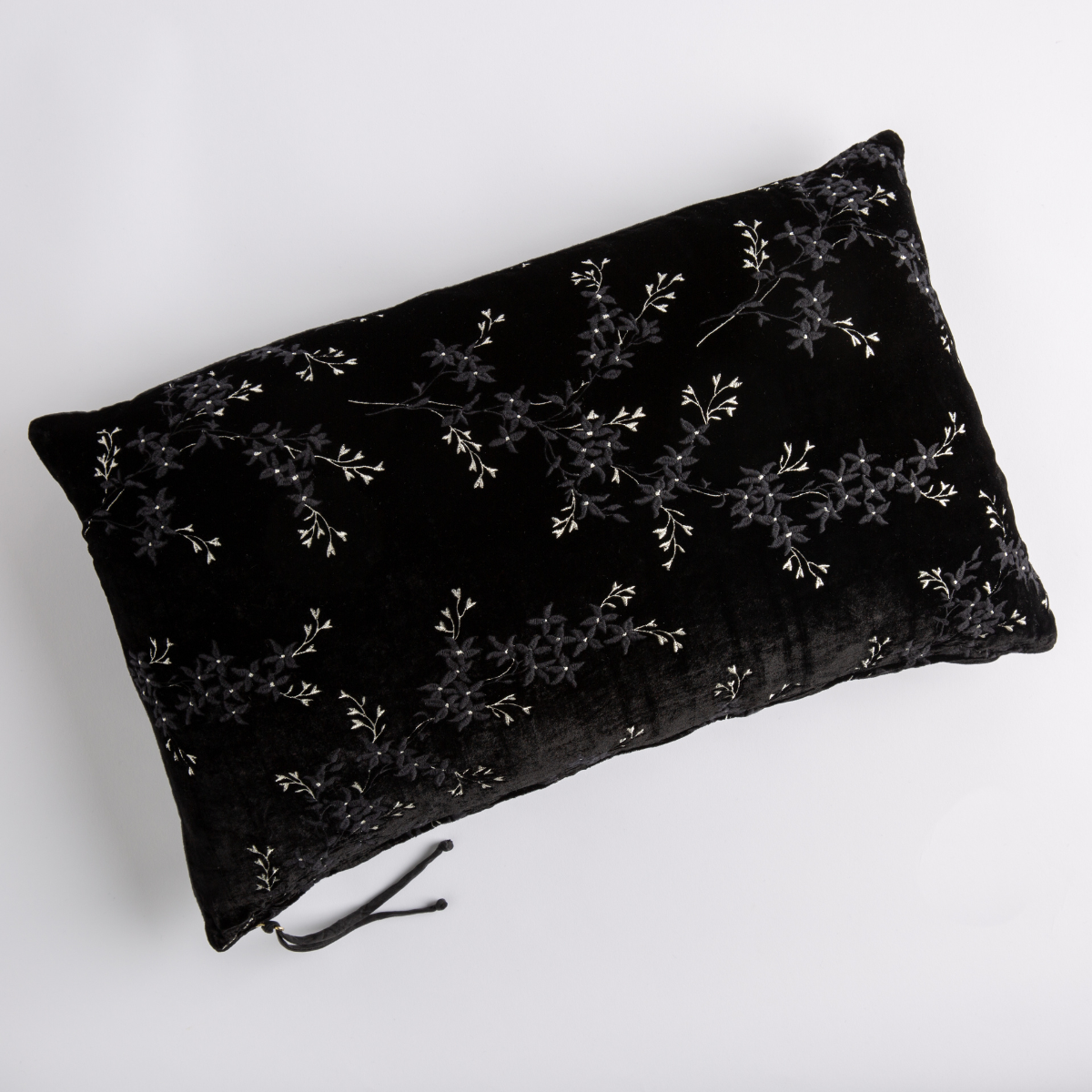 Corvino: overhead of 15x24 embroidered silk velvet pillow against a white background