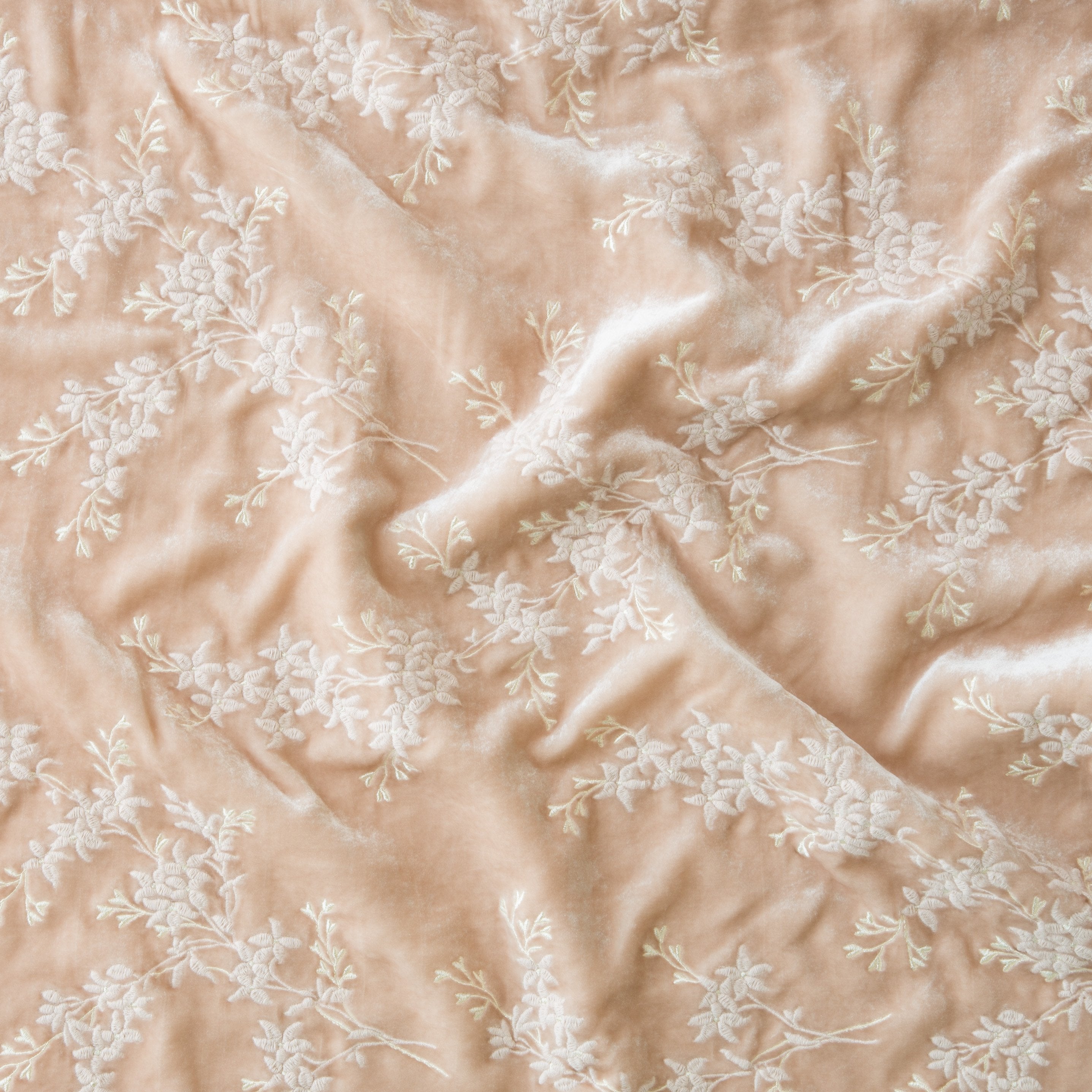 Pearl: A close up of Lynette embroidered silk velvet, in pearl, a nude-like, soft rose pink tone.