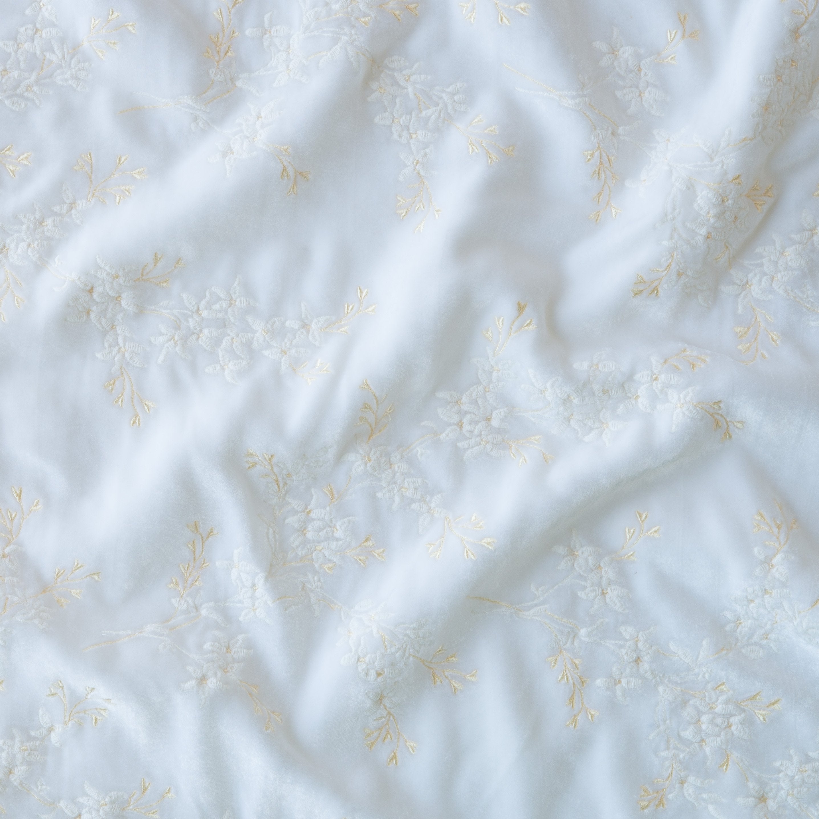 White: A close up of Lynette embroidered silk velvet, in white.