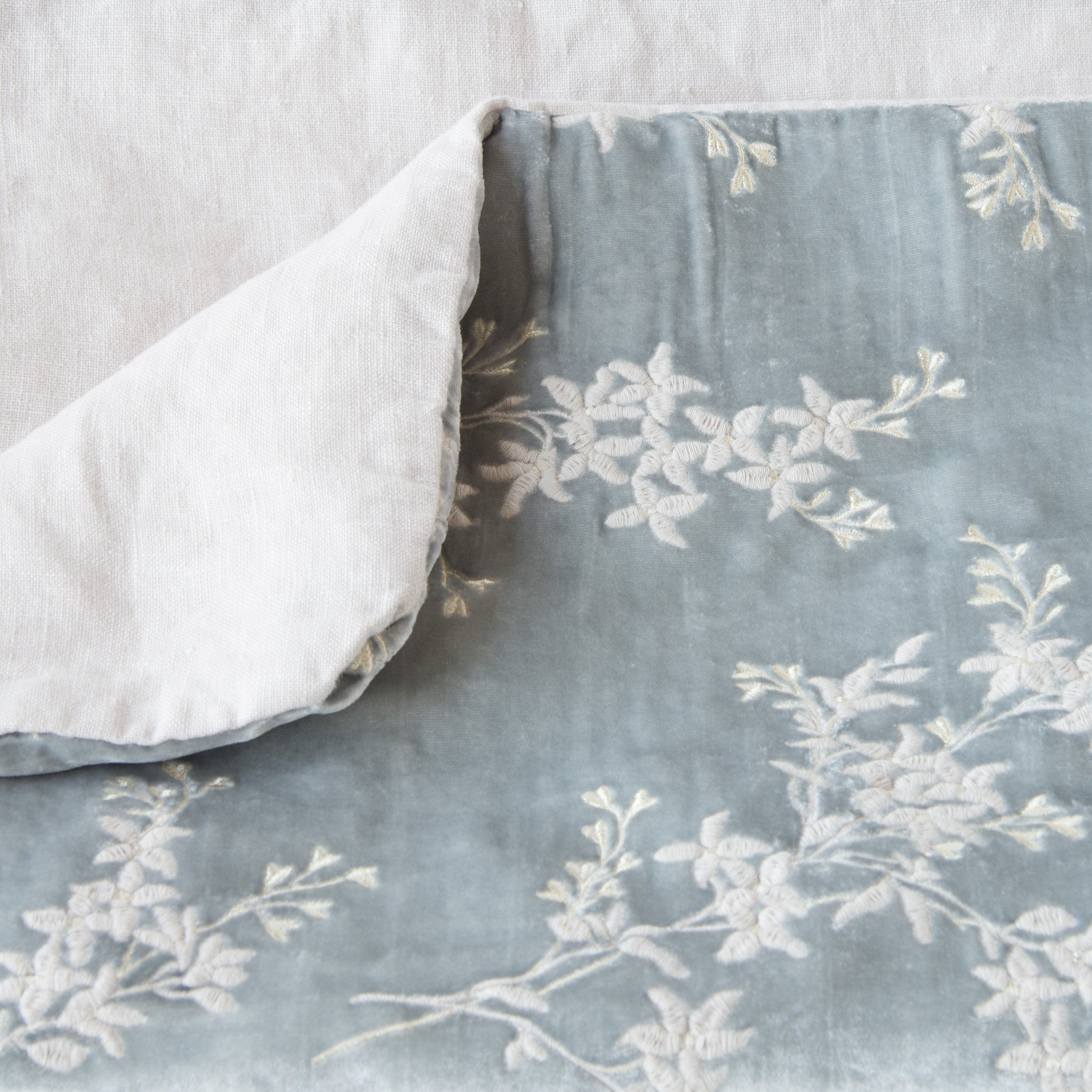 Sterling: Close up of blanket, with a corner turned back to showcase the linen back - overhead view.