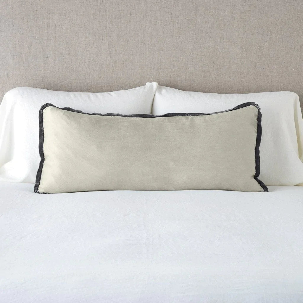Fog: 16x36 charmeuse pllow wth silk velvet trim against white sleeping pillows and sheets — straight on with neutral background.