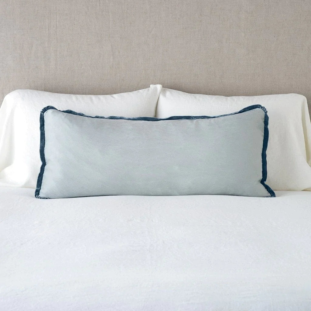 Mineral: 16x36 charmeuse pllow wth silk velvet trim against white sleeping pillows and sheets — straight on with neutral background.