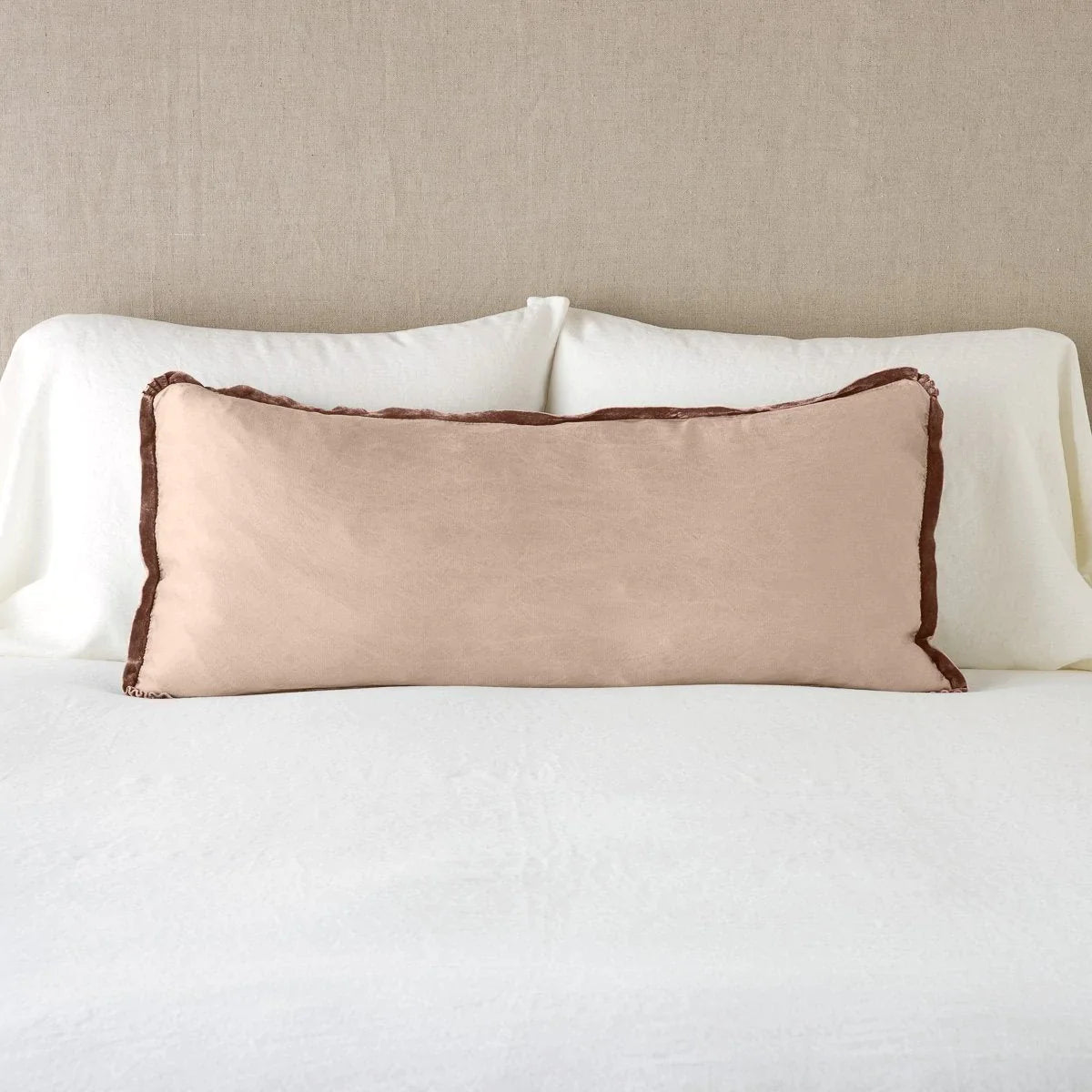 Rouge: 16x36 charmeuse pllow wth silk velvet trim against white sleeping pillows and sheets — straight on with neutral background.