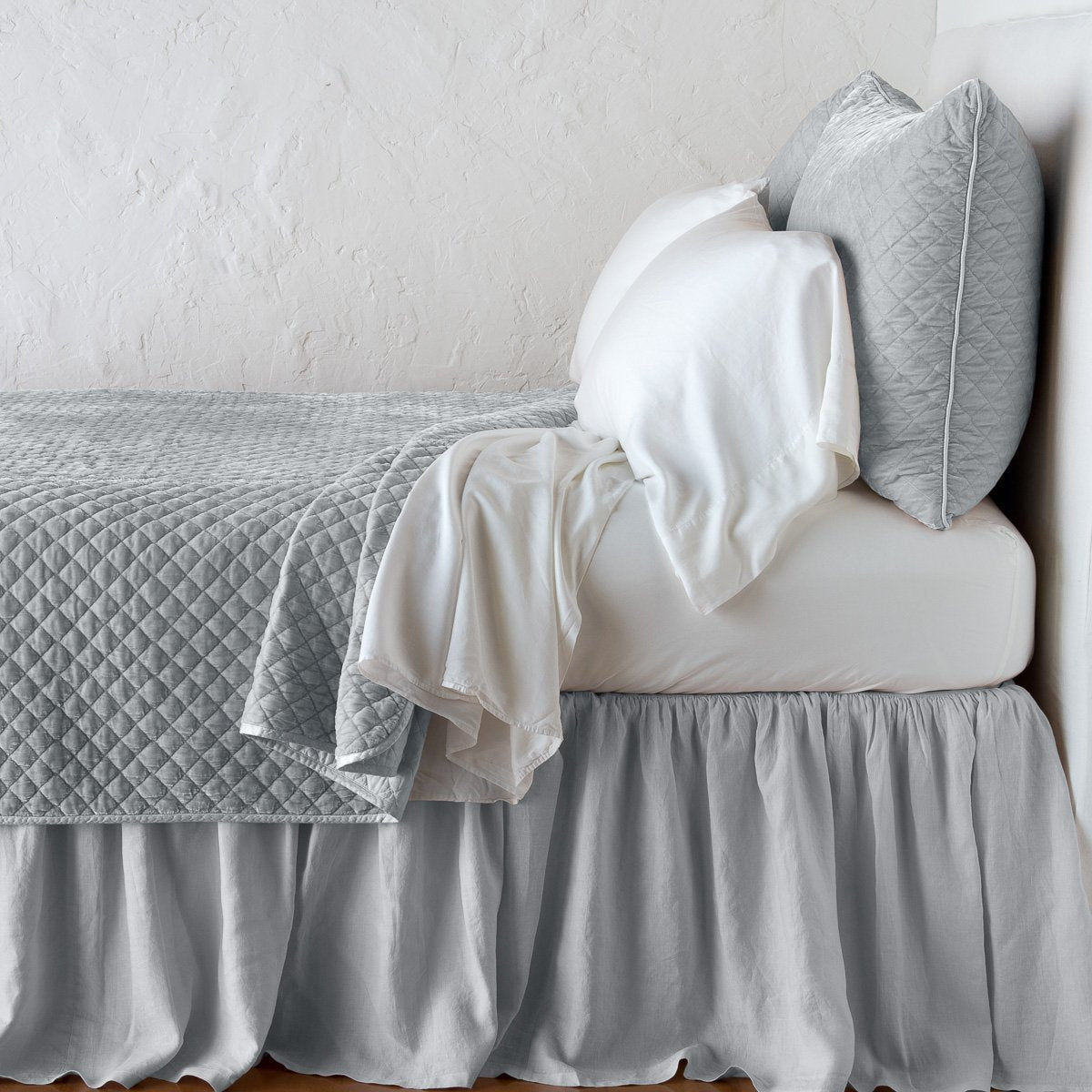 Sterling: coverlet with matching shams and white sheeting - side view.