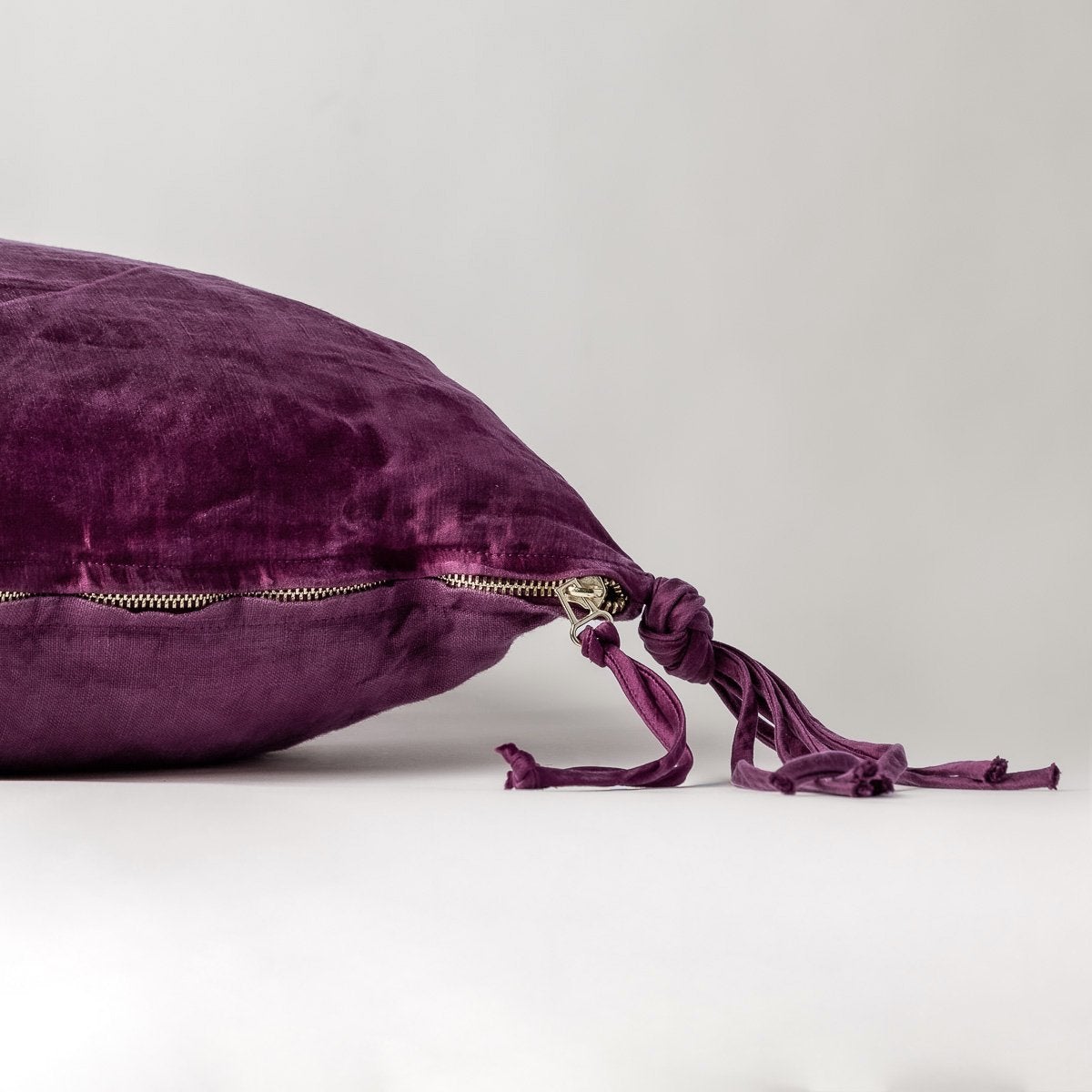 Fig: Close-up side vew featuring brass zipper with charmeuse pull and linen back.