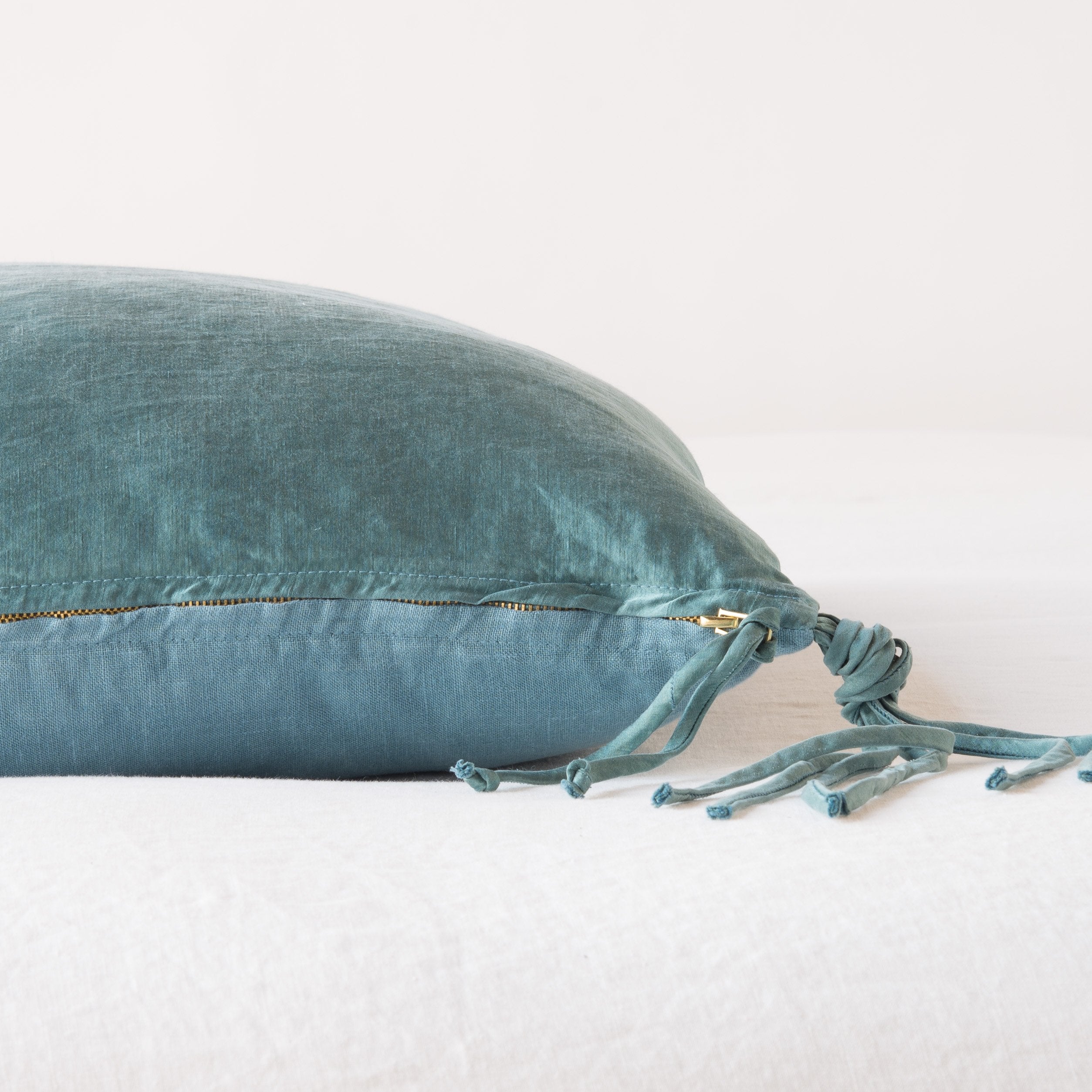 Cenote: Close-up side vew featuring brass zipper with charmeuse pull and linen back.